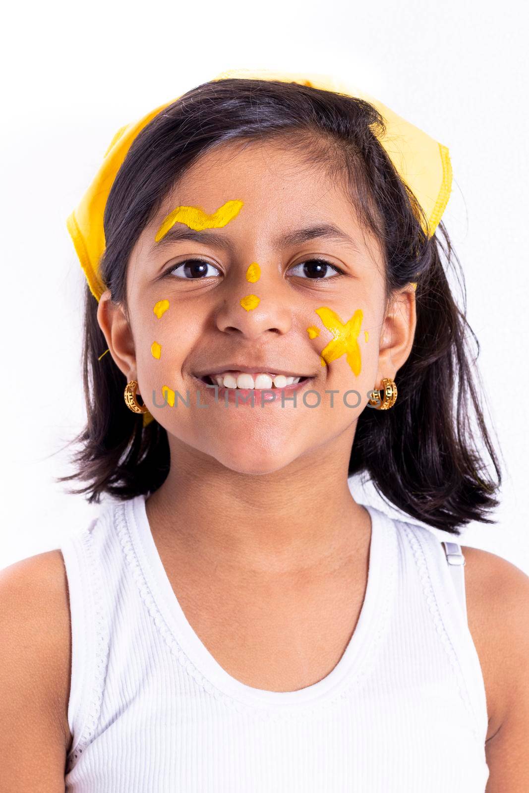 Happy little girl, with her face painted to celebrate the yellow day