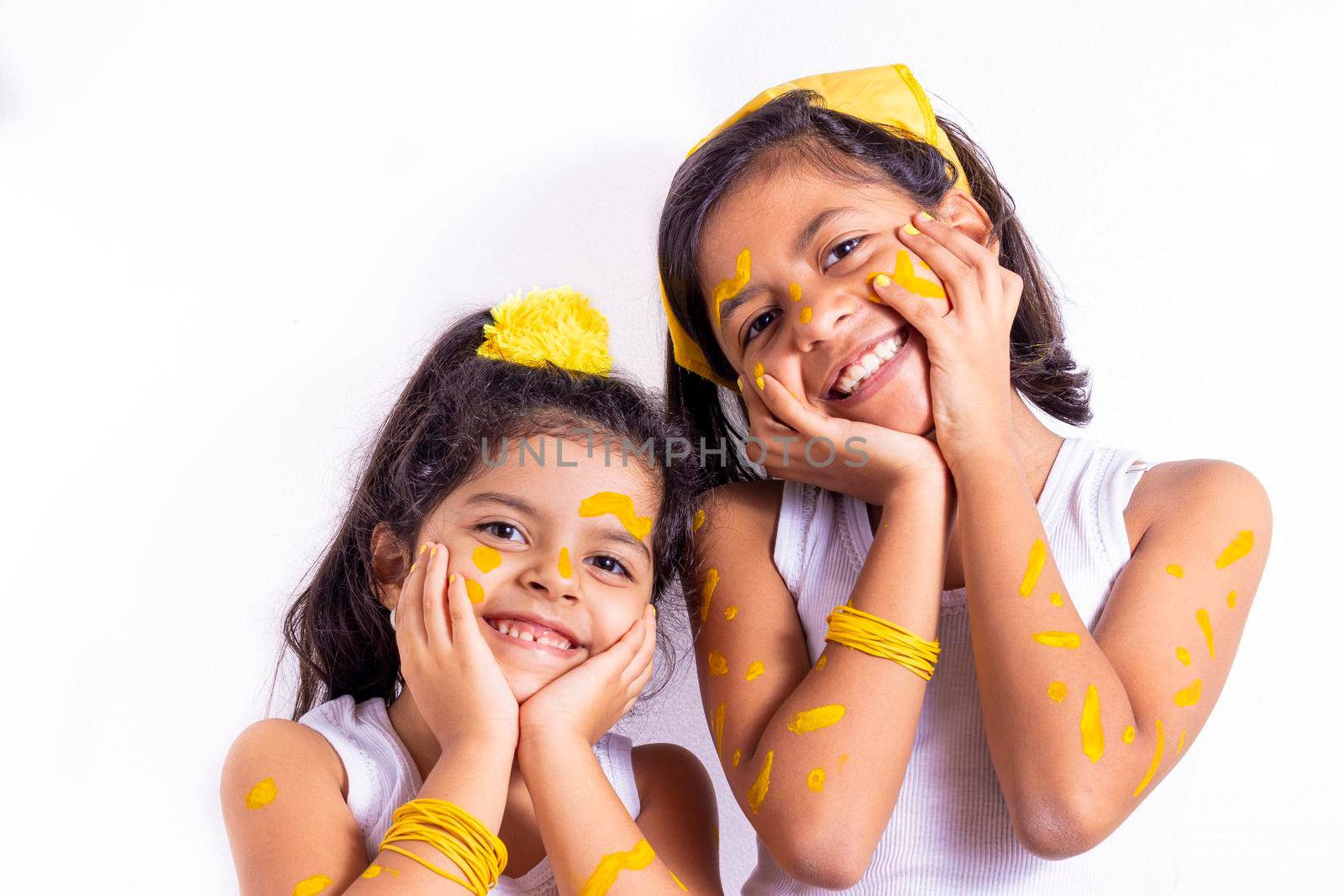 Two little girl, with her face painted to celebrate the yellow day by eagg13