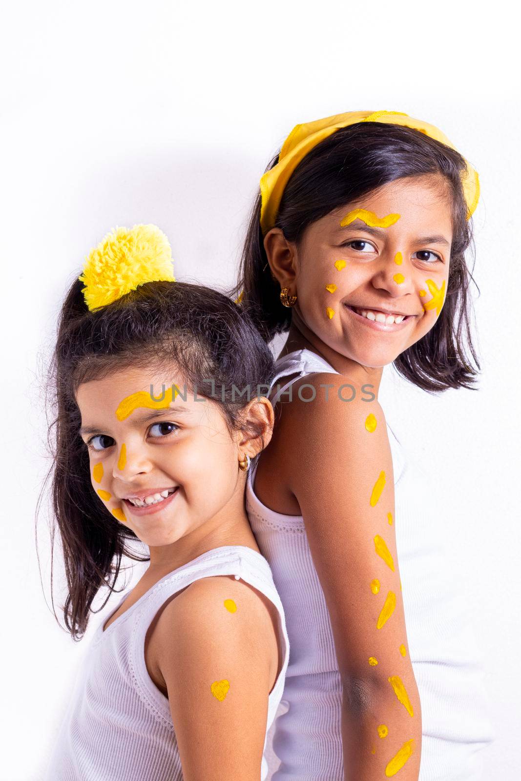 Two little girl, with her face painted to celebrate the yellow day