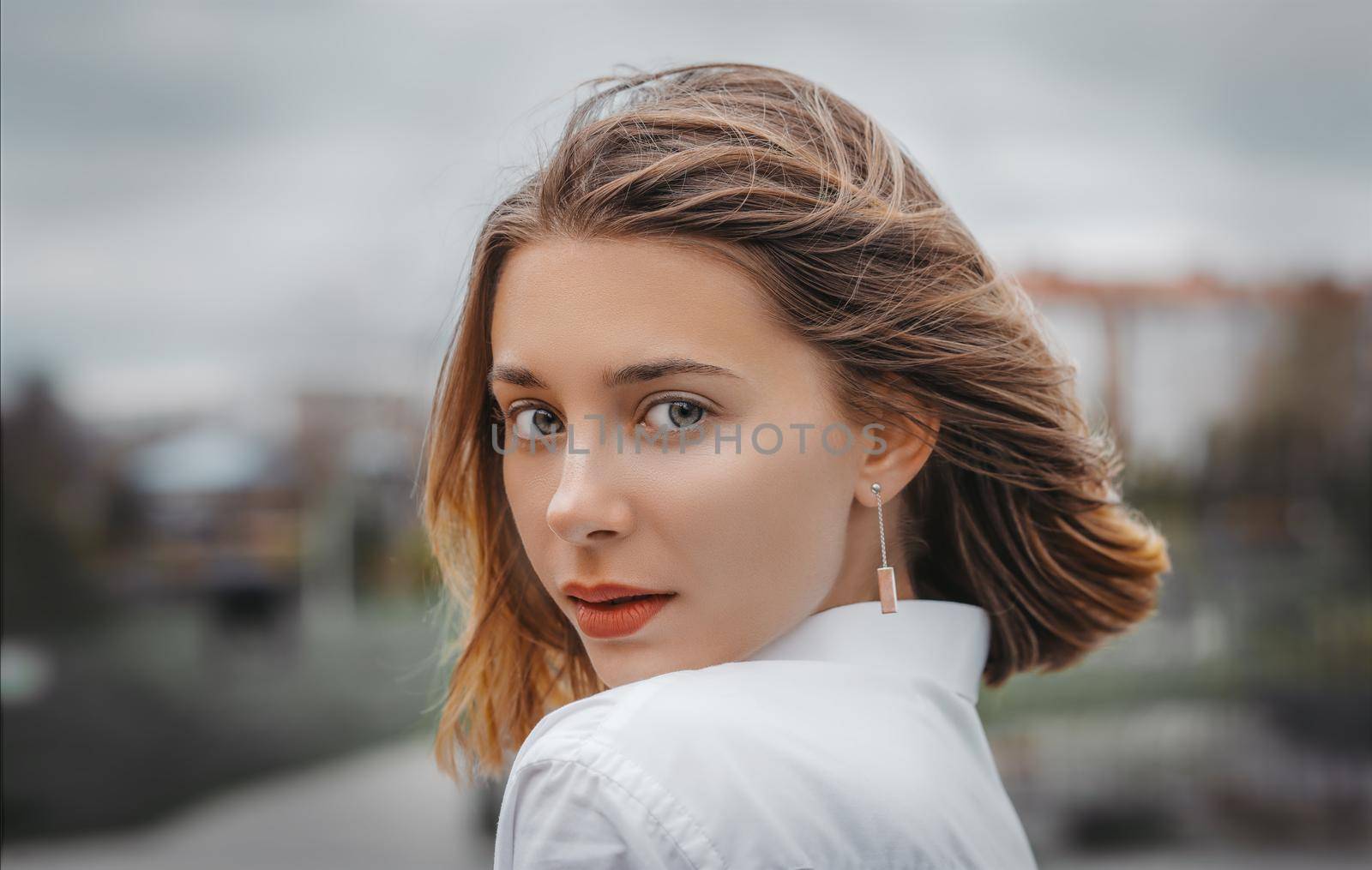 Close up portrait of a young woman in the city. Selective focus