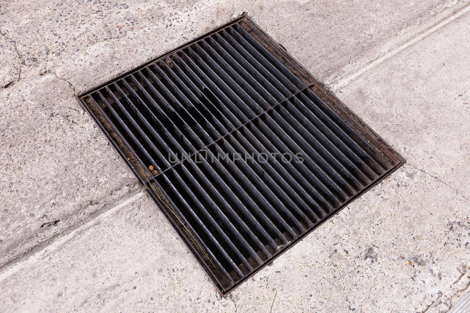 Old steel drainage grating on road by smuay
