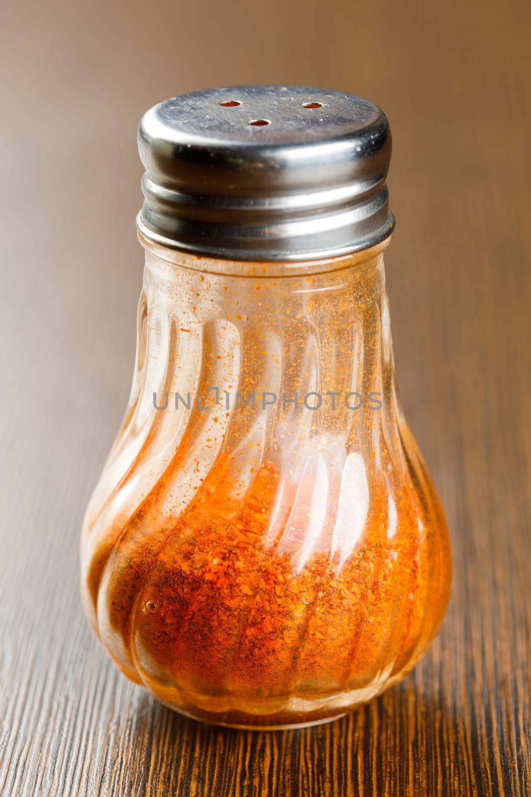 Ground chilli in glass bottle by smuay