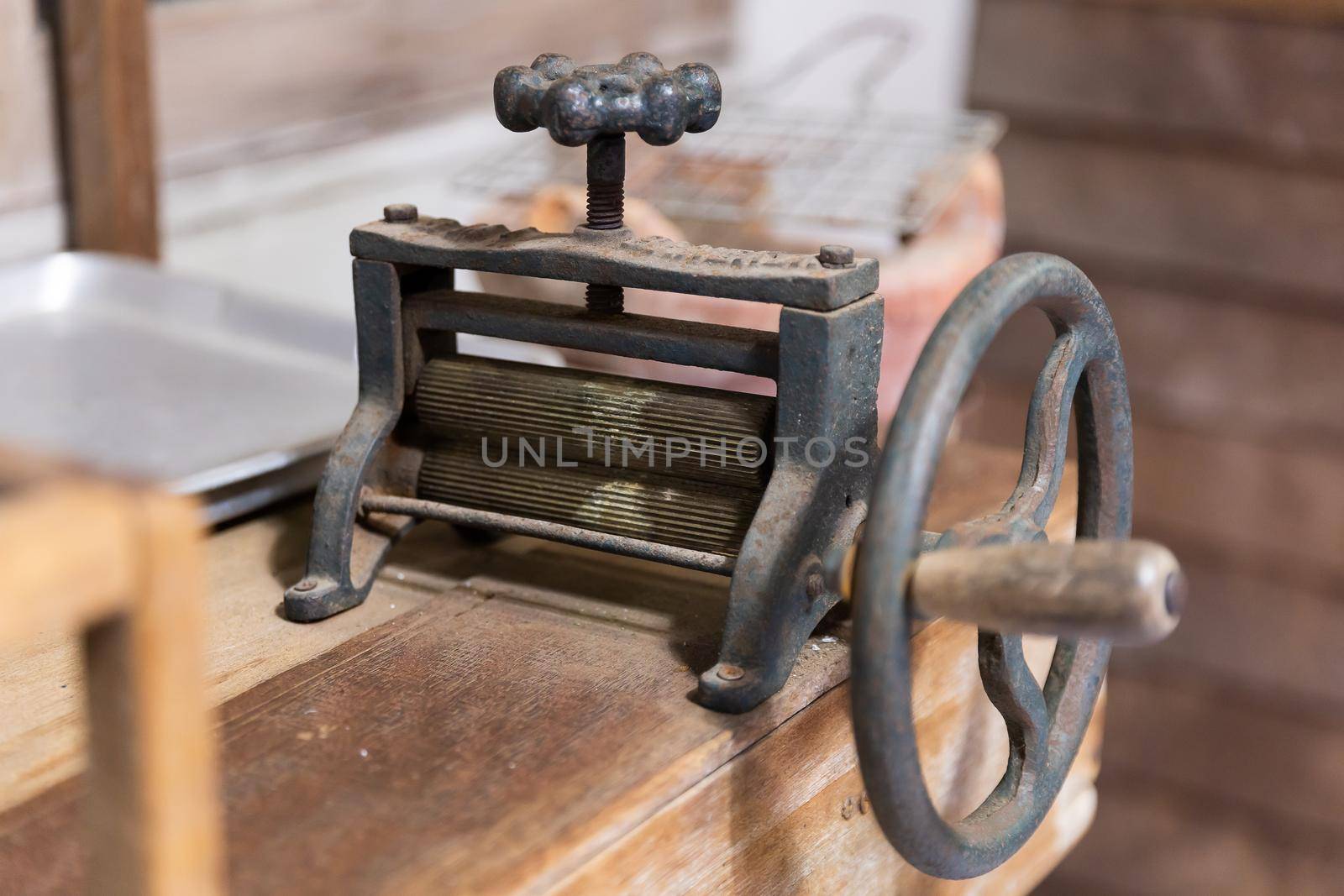 Old and rusty manual dried squid flatten roller machine, brass and cast iron tool