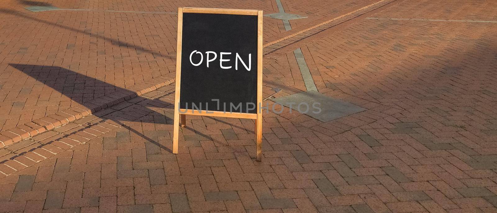 Open sign on blackboard, reopening after covid 19 lockdown