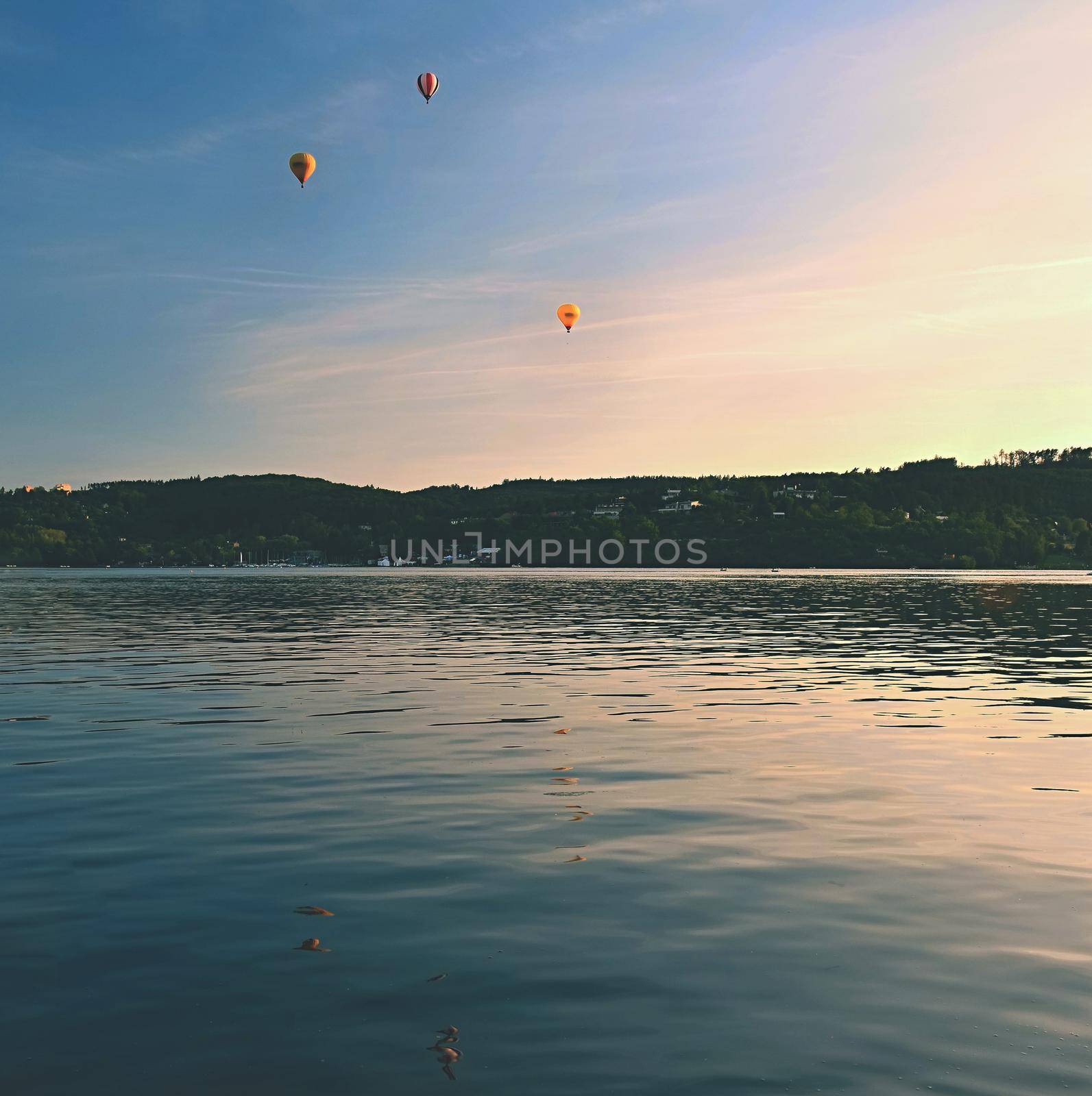 Beautiful colorful hot air balloon is flying at sunset. Brno Dam - Czech Republic.