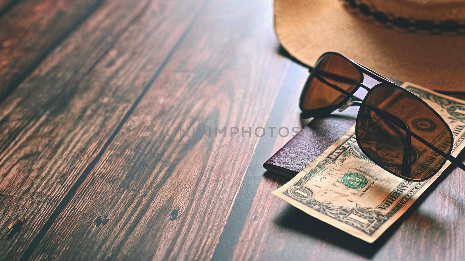 Items for summer vacation: a camera, passport,smartphone, money, hat, sunglasses. Wooden background, top view with Copy space. Beautiful summer concept for travel.