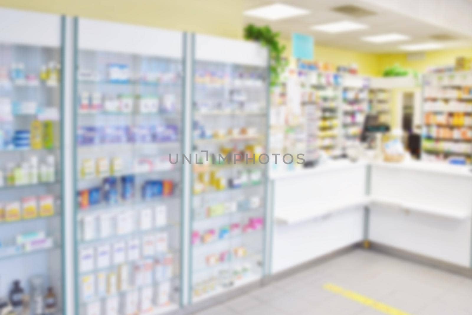 Blurred background. Interior of a pharmacy with goods and showcases. Medicines and vitamins for health. Concept for medicine and health - Coronavirus - COVID 19. by Montypeter