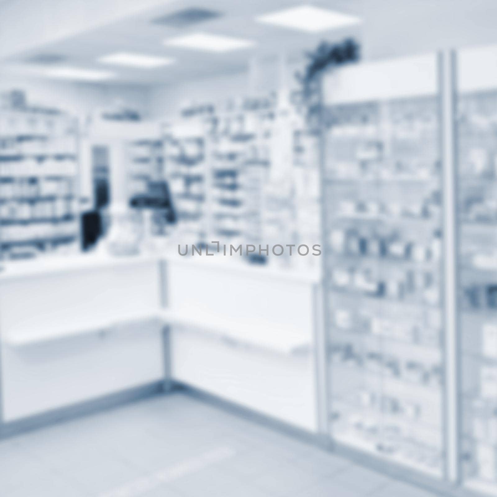 Blurred background. Interior of a pharmacy with goods and showcases. Medicines and vitamins for health. Concept for medicine and health - Coronavirus - COVID 19.