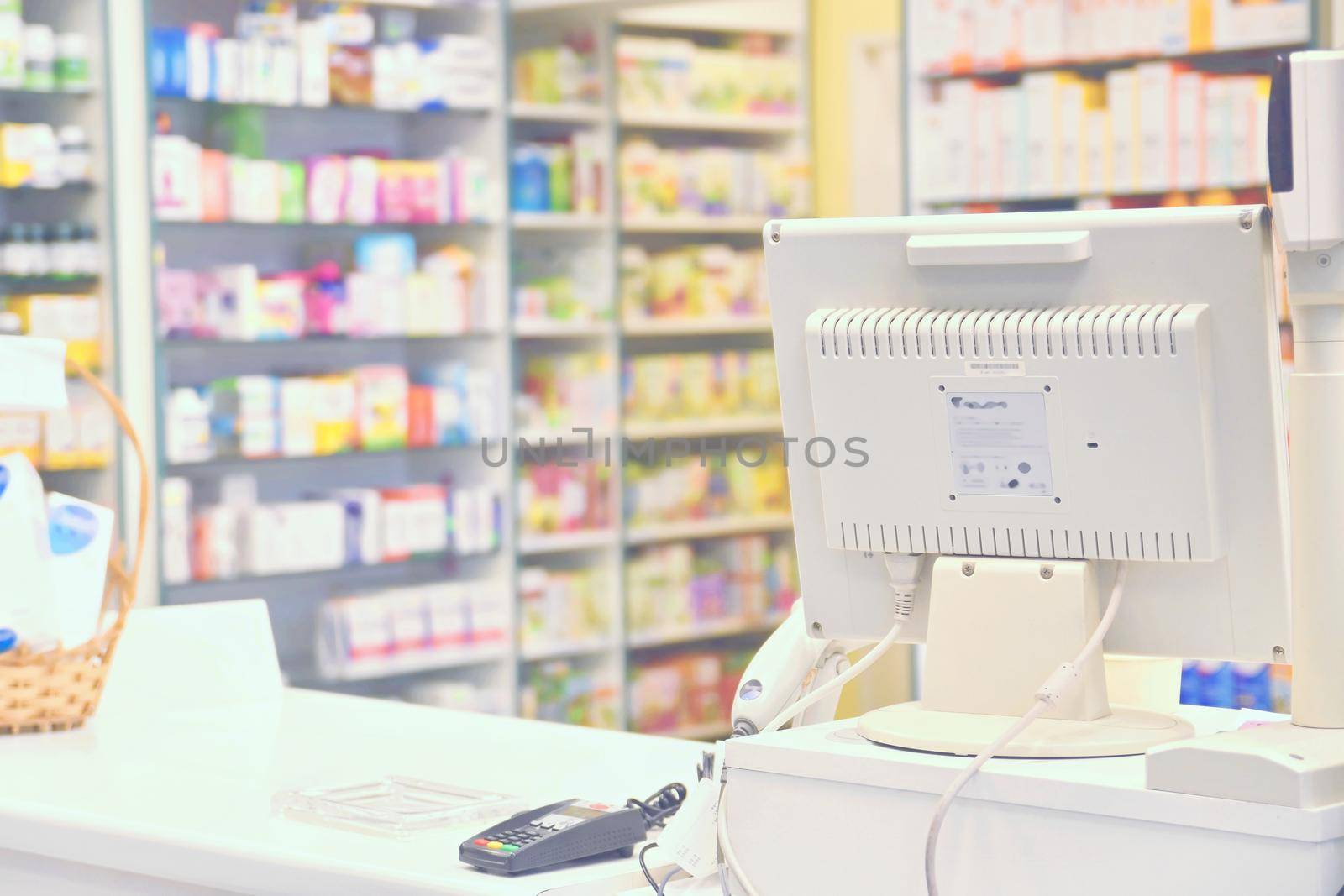 Cash desk - computer and monitor in a pharmacy. Interior of drug and vitamins shop. Concept for medicine and health - Coronavirus - COVID 19.
