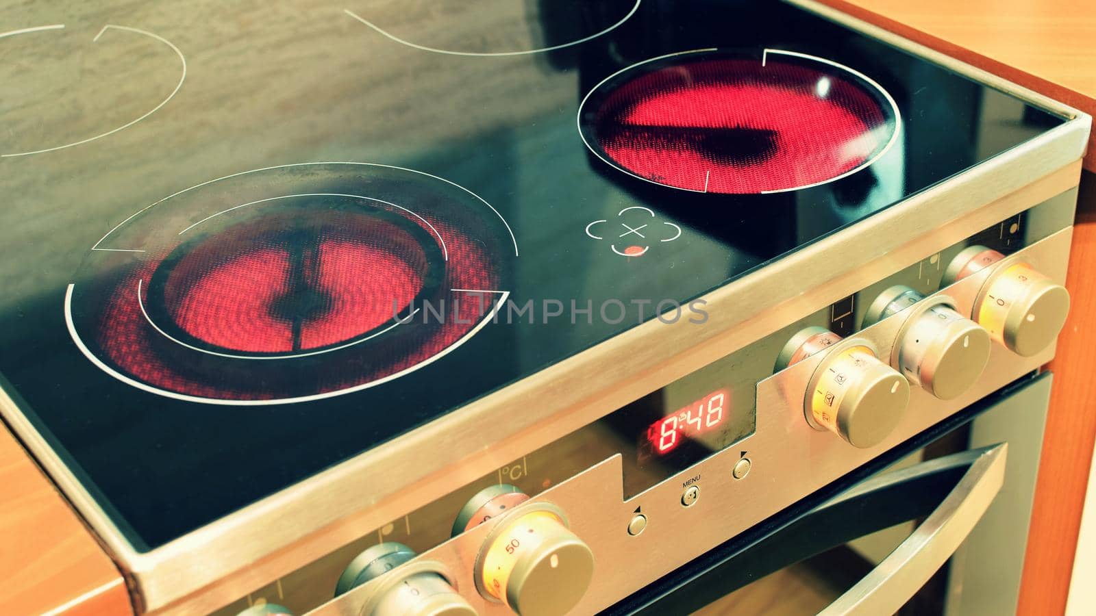 Electric ceramic stove inside the kitchen. Nice detail of a home appliance in a house interior. by Montypeter