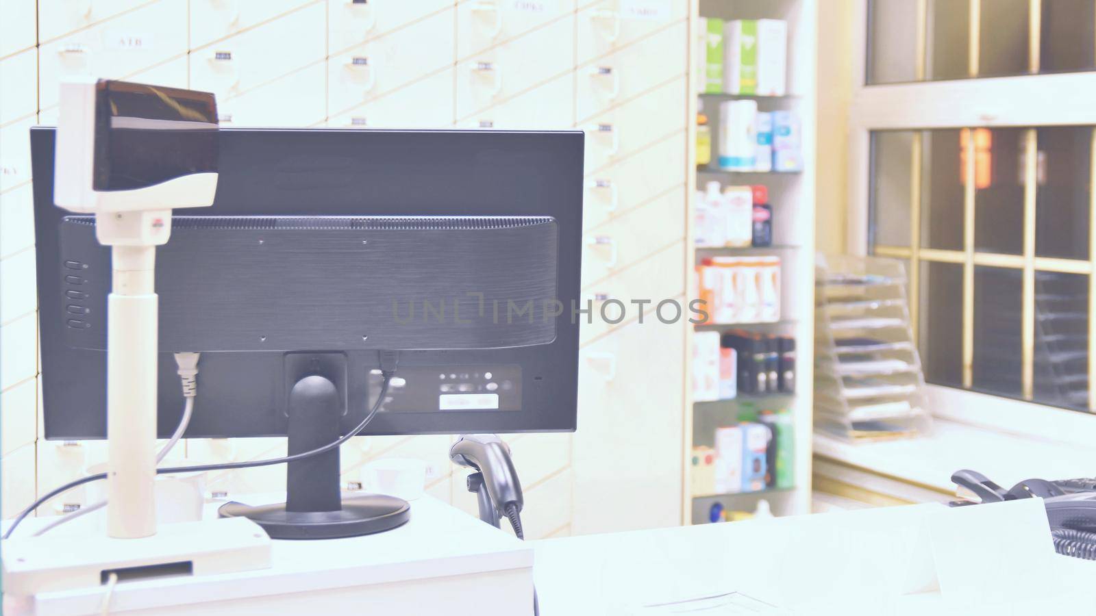 Cash desk - computer and monitor in a pharmacy. Interior of drug and vitamins shop. Concept for medicine and health - Coronavirus - COVID 19. by Montypeter