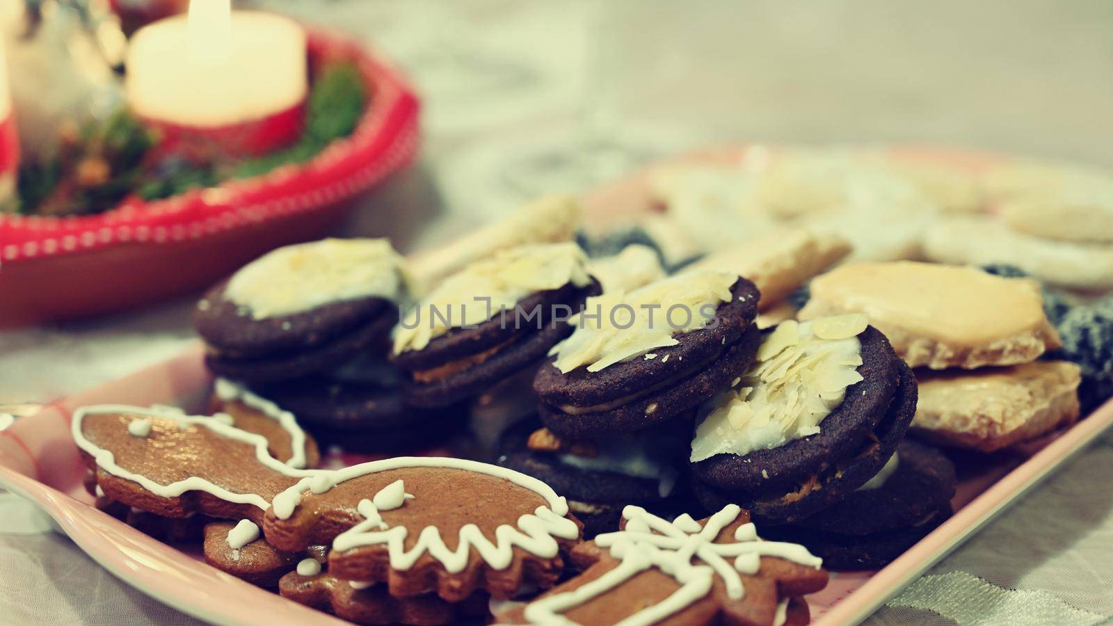 Beautifully set table for Christmas holidays. Candies, candles and Christmas decorations - decorated home on Christmas Eve. by Montypeter