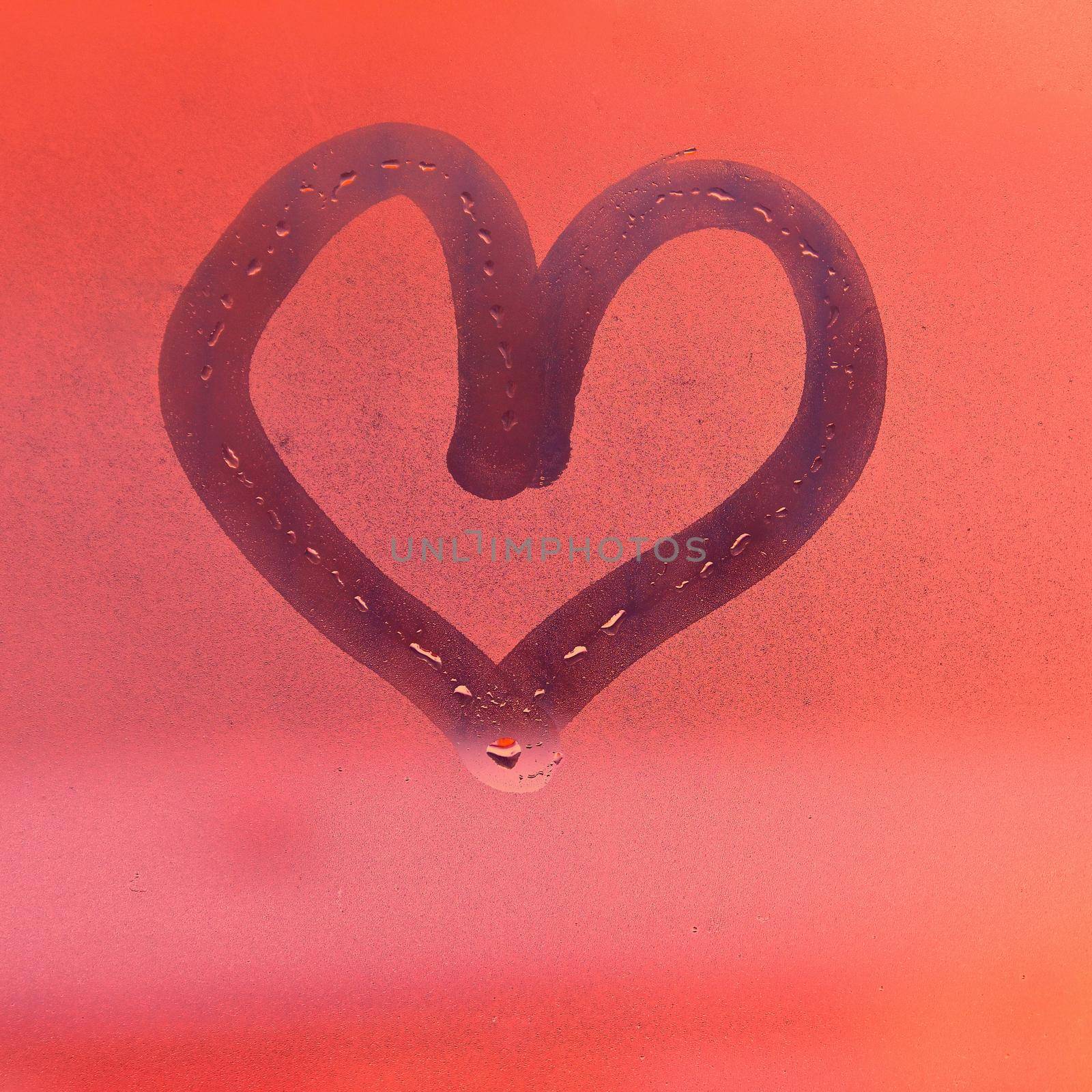 Heart painted with finger on foggy window