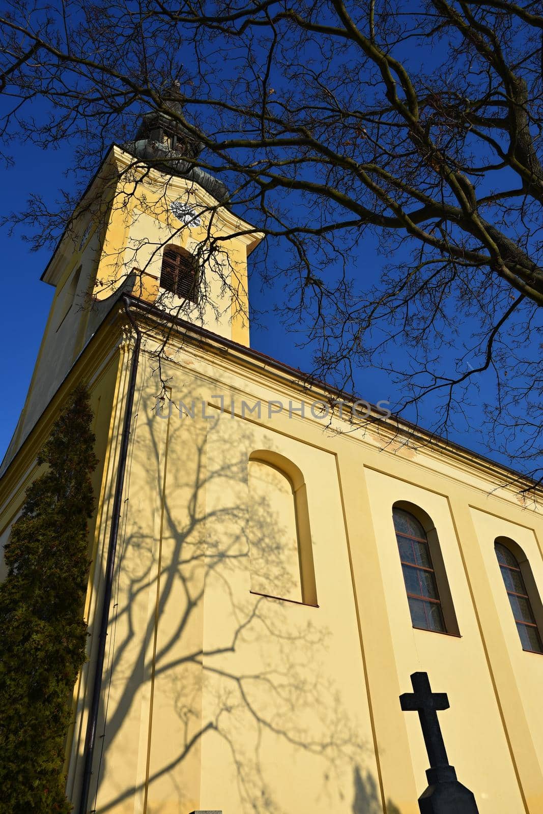 Beautiful old church with a cross and a blue sky. by Montypeter