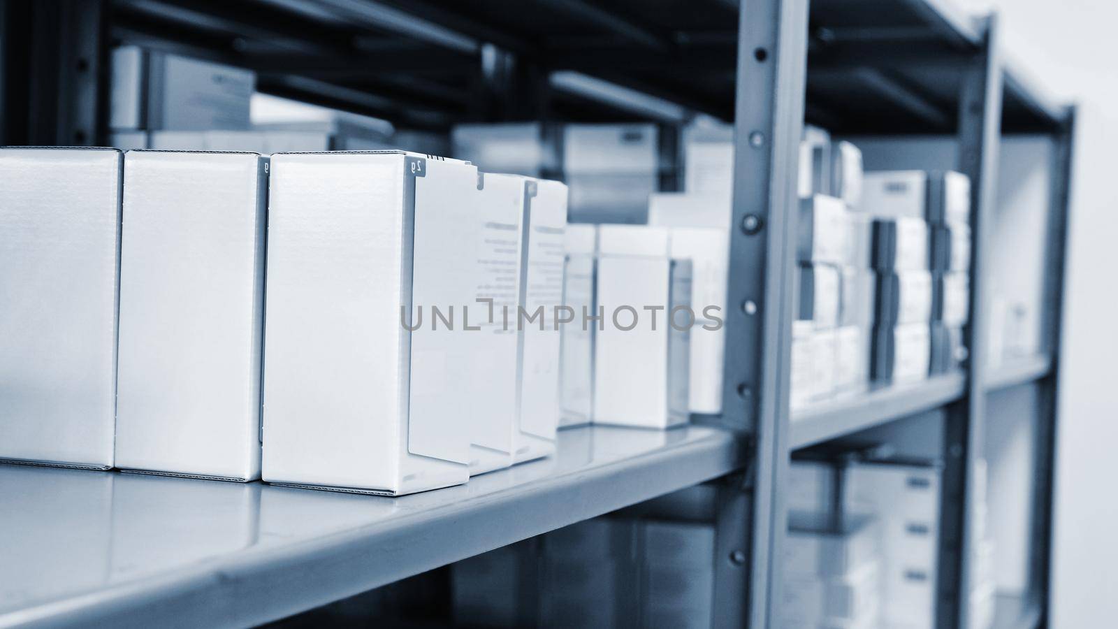 Drug boxes in a shelf in a pharmacy. Store of medicines and vitamins. Background for sale in a pharmacy and health lifestyle.