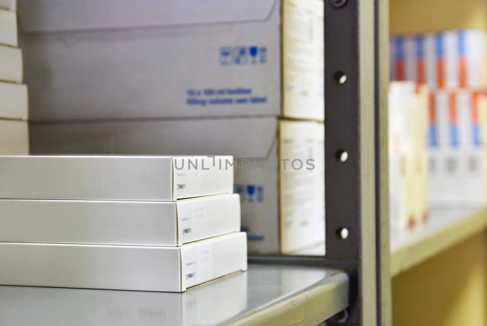Drug boxes in a shelf in a pharmacy. Store of medicines and vitamins. Background for sale in a pharmacy and health lifestyle.