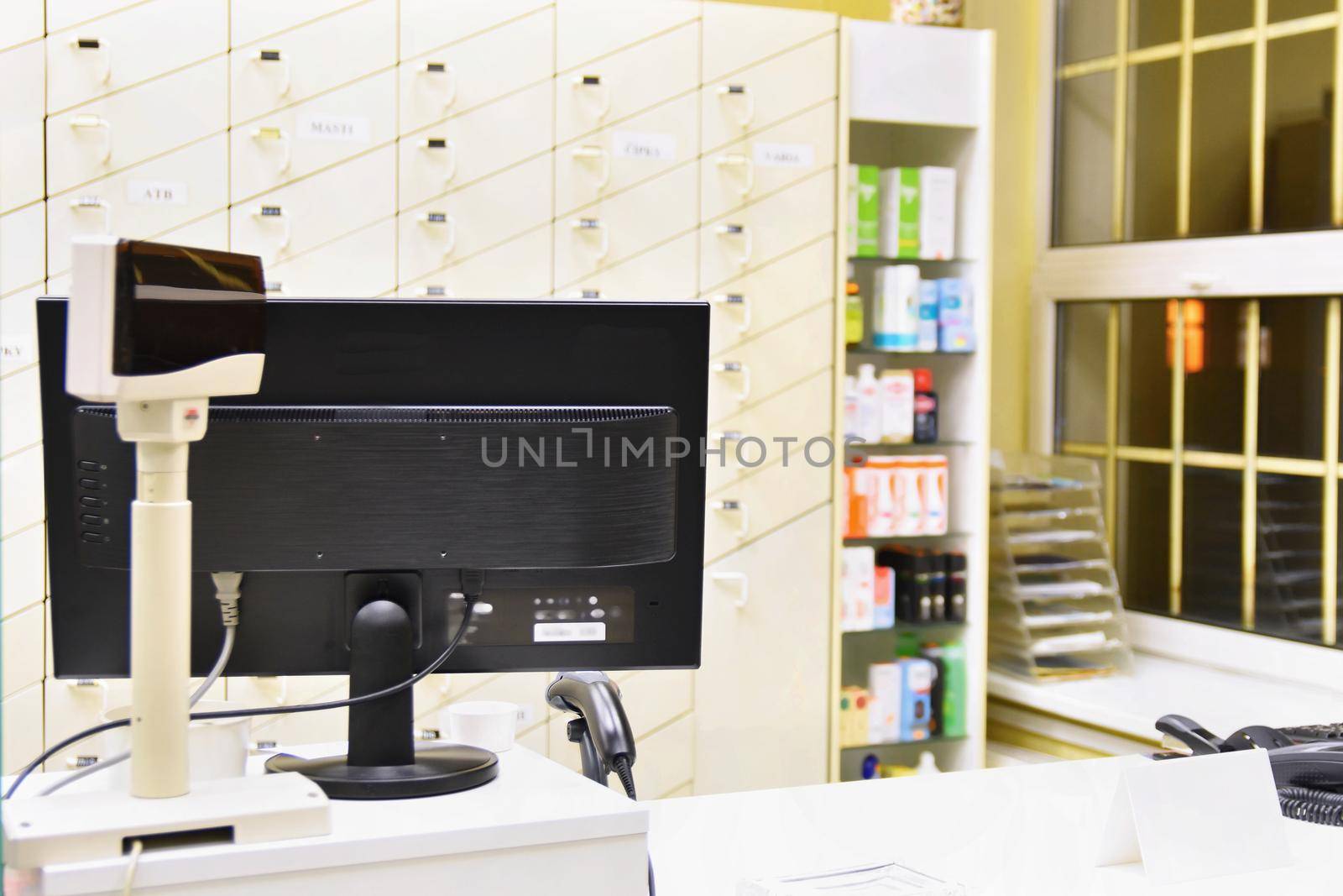 Cash desk - computer and monitor in a pharmacy. Interior of drug and vitamins shop. Medicines and vitamins for health and healthy lifestyle.  