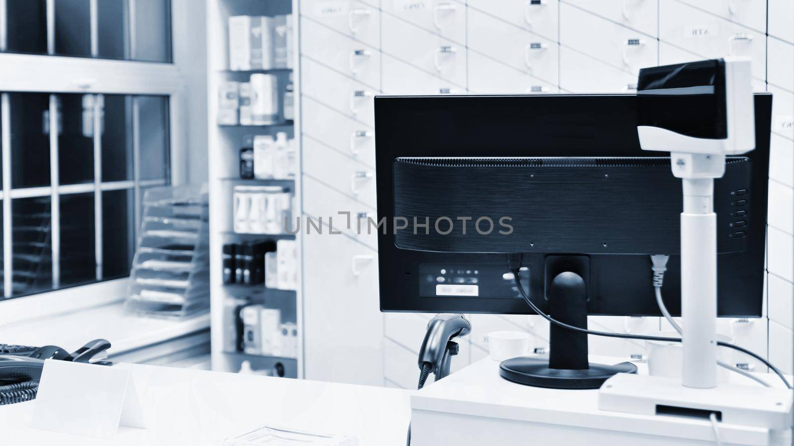 Cash desk - computer and monitor in a pharmacy. Interior of drug and vitamins shop. Medicines and vitamins for health and healthy lifestyle.  