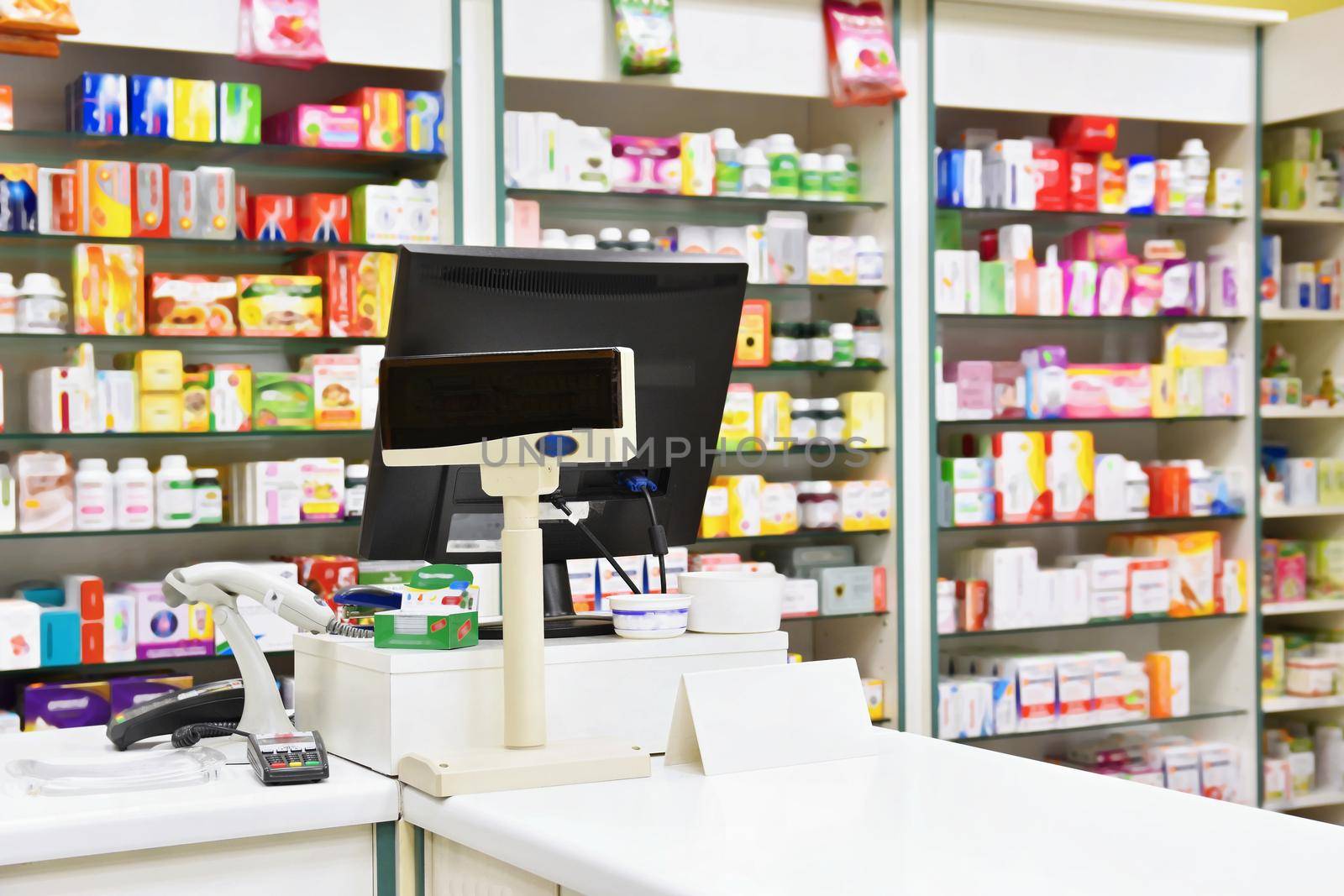 Cash desk - computer and monitor in a pharmacy. Interior of drug and vitamins shop. Medicines and vitamins for health and healthy lifestyle.  