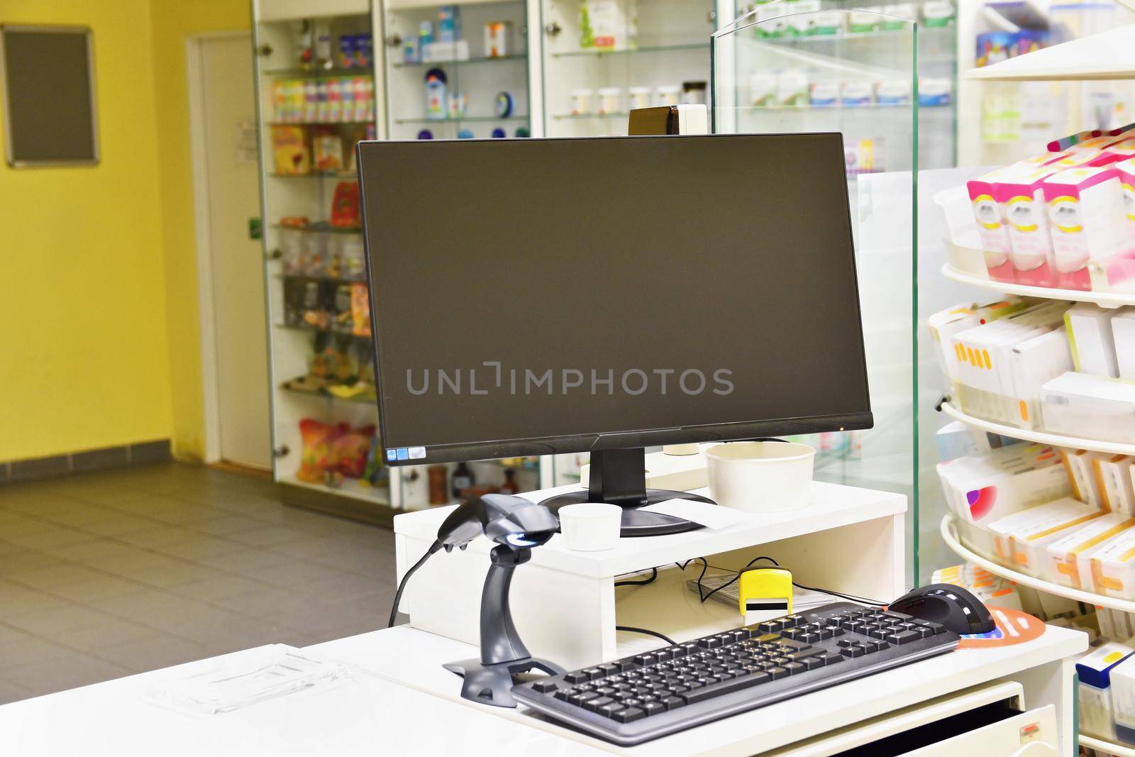 Cash desk - computer and monitor in a pharmacy. Interior of drug and vitamins shop. Medicines and vitamins for health and healthy lifestyle.  