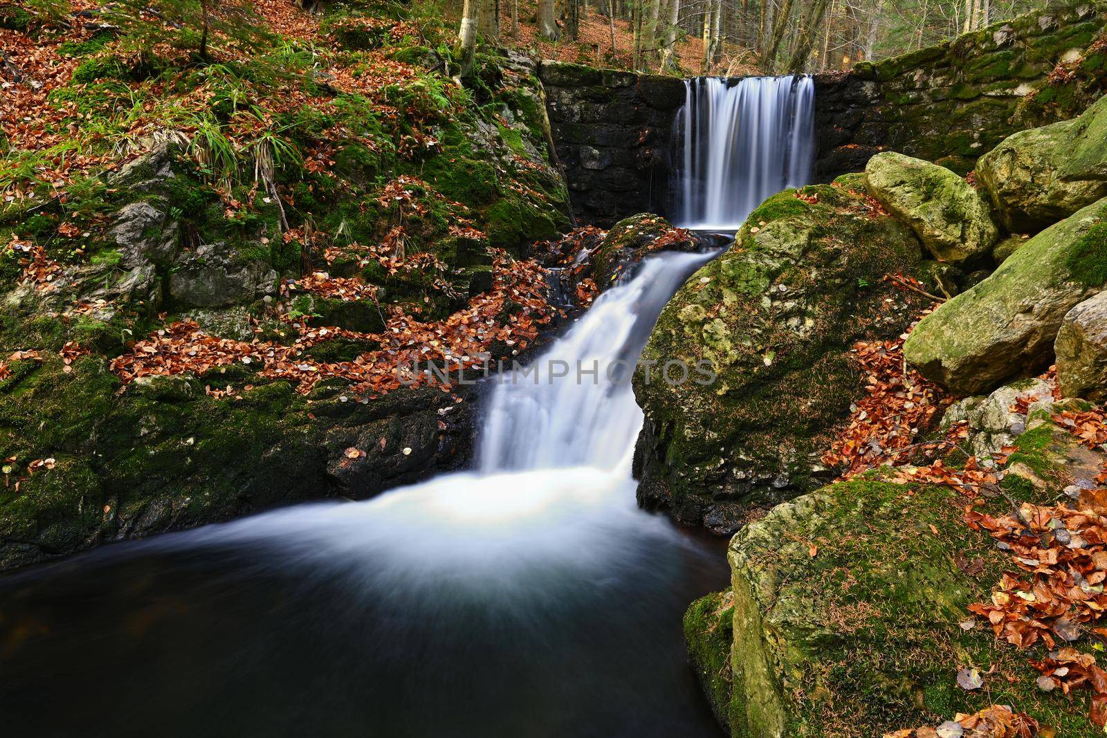 Beautiful colorful background with river and stones in autumn time. White Opava Waterfalls - Jeseniky Mountains - Czech Republic.