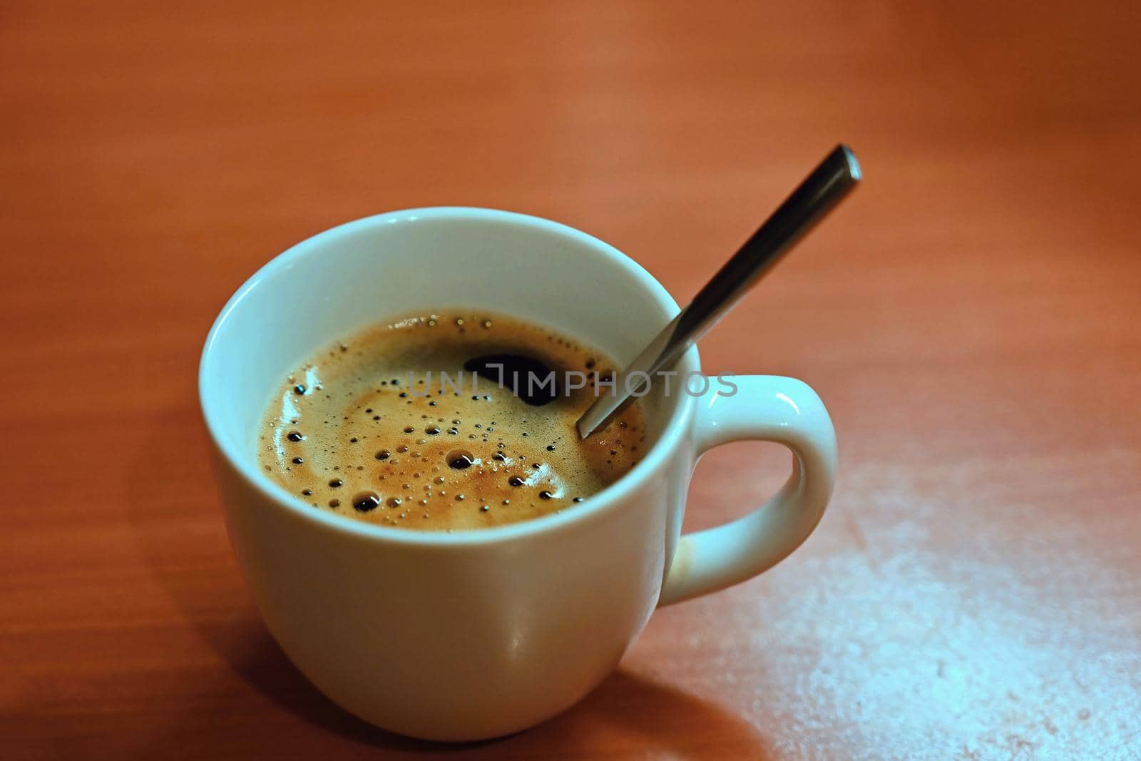 Coffee Espresso. White small cup of coffee on the wooden background.