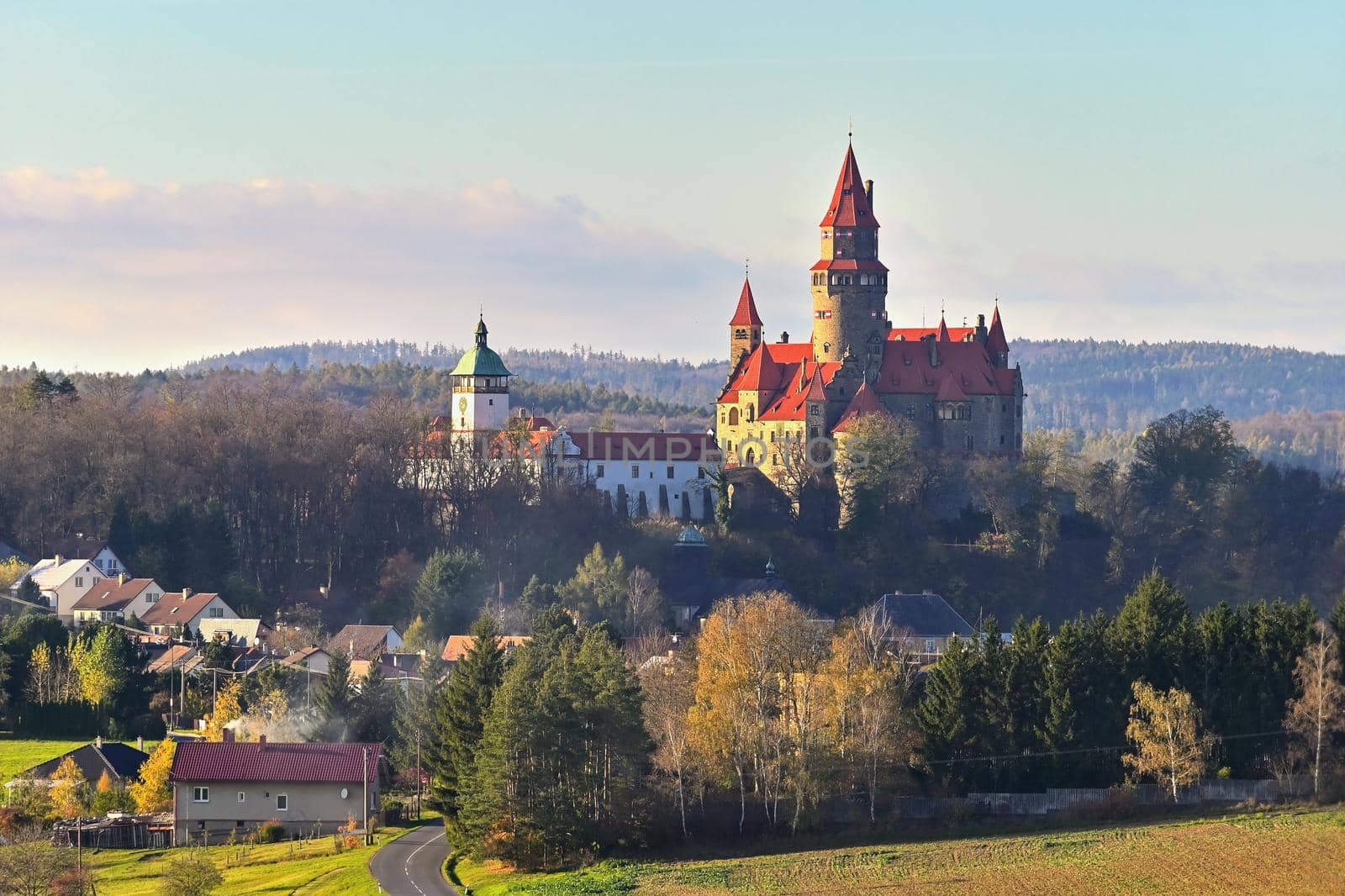 Beautiful old romantic Bouzov castle at sunset with autumn landscape.