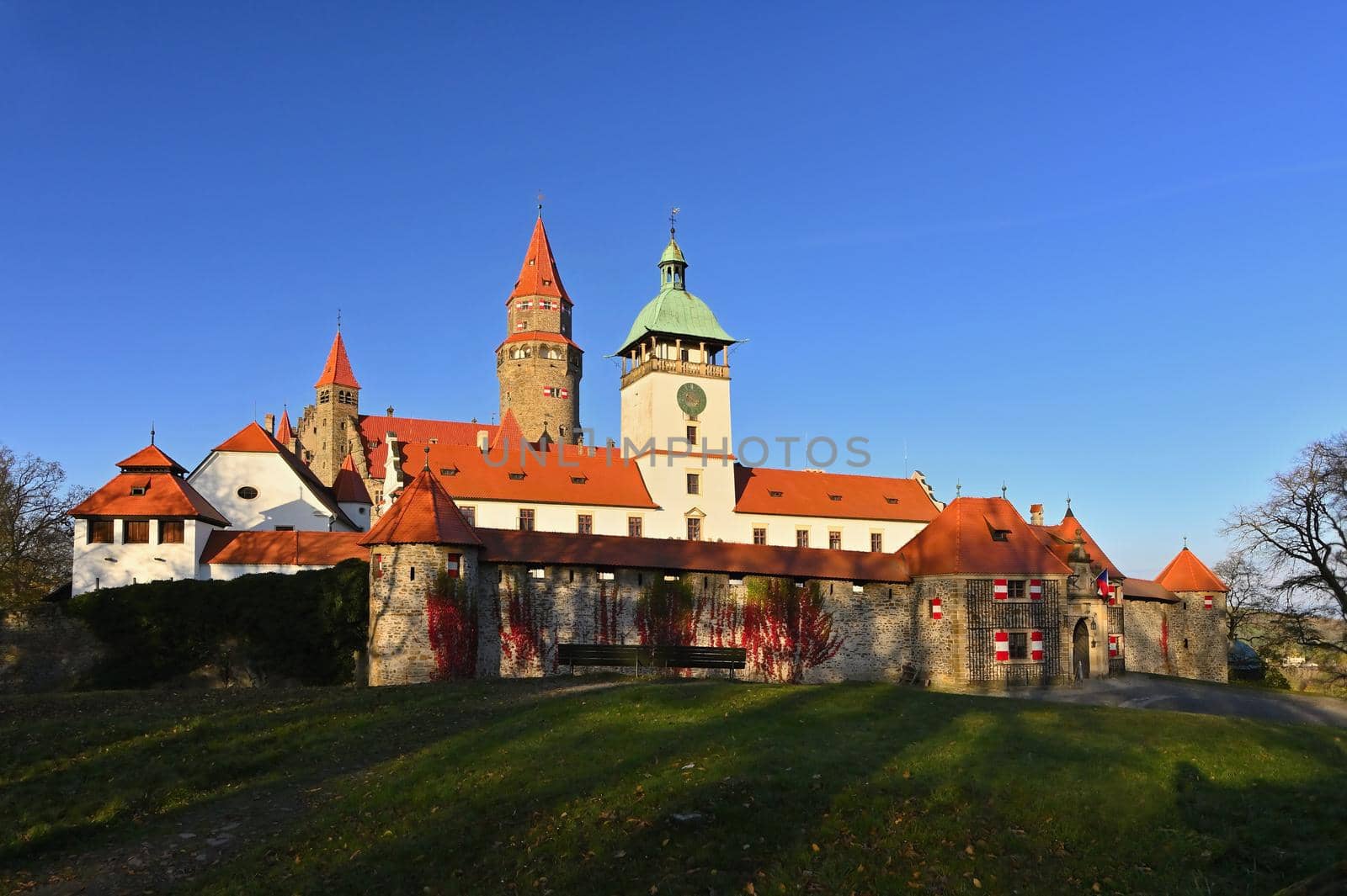 Beautiful old romantic Bouzov castle at sunset with autumn landscape. by Montypeter