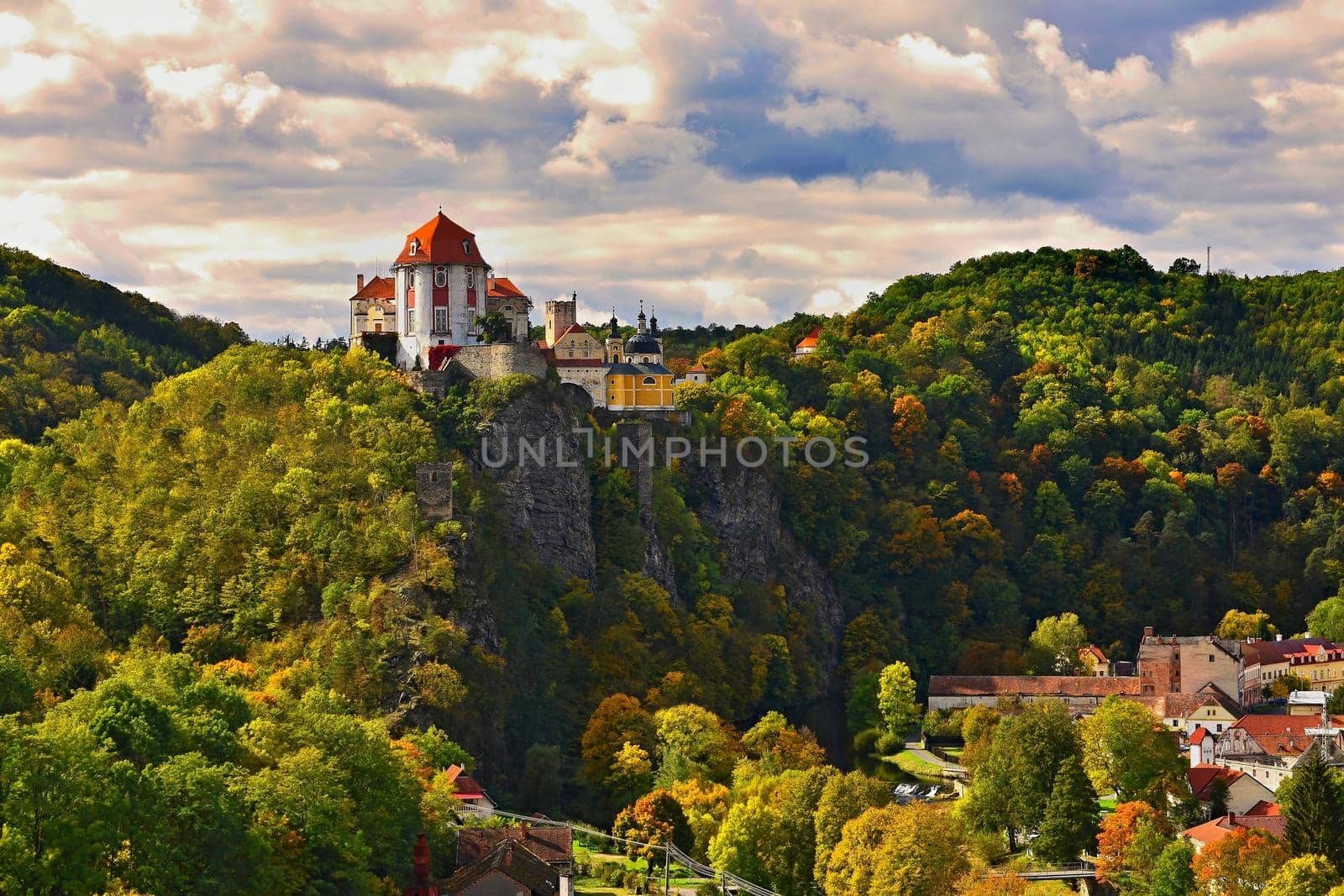 Beautiful autumn landscape with river, castle and blue sky with clouds and sun. Vranov nad Dyji (Vranov above Thaya) chateau, river Thaya, Czech Republic.