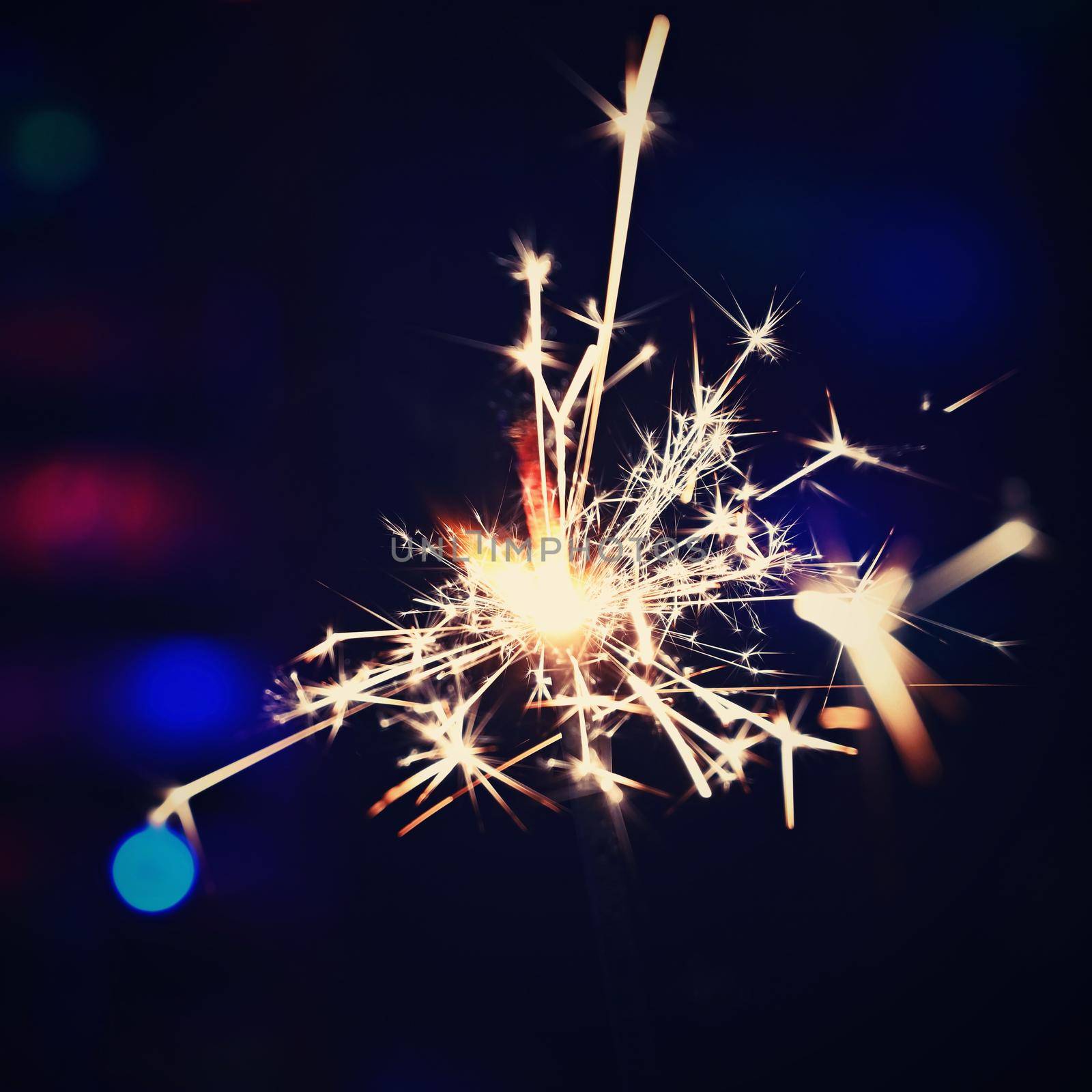 Concept for Christmas and Happy New Year.
Burning sparkler with beautiful color background.
