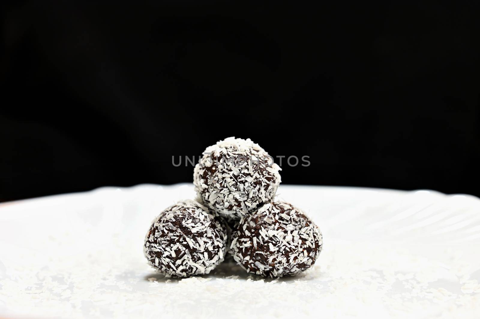 Rum balls in coconut. Classic Czech Christmas cookies. Hand made unbaked sweets with alcohol.