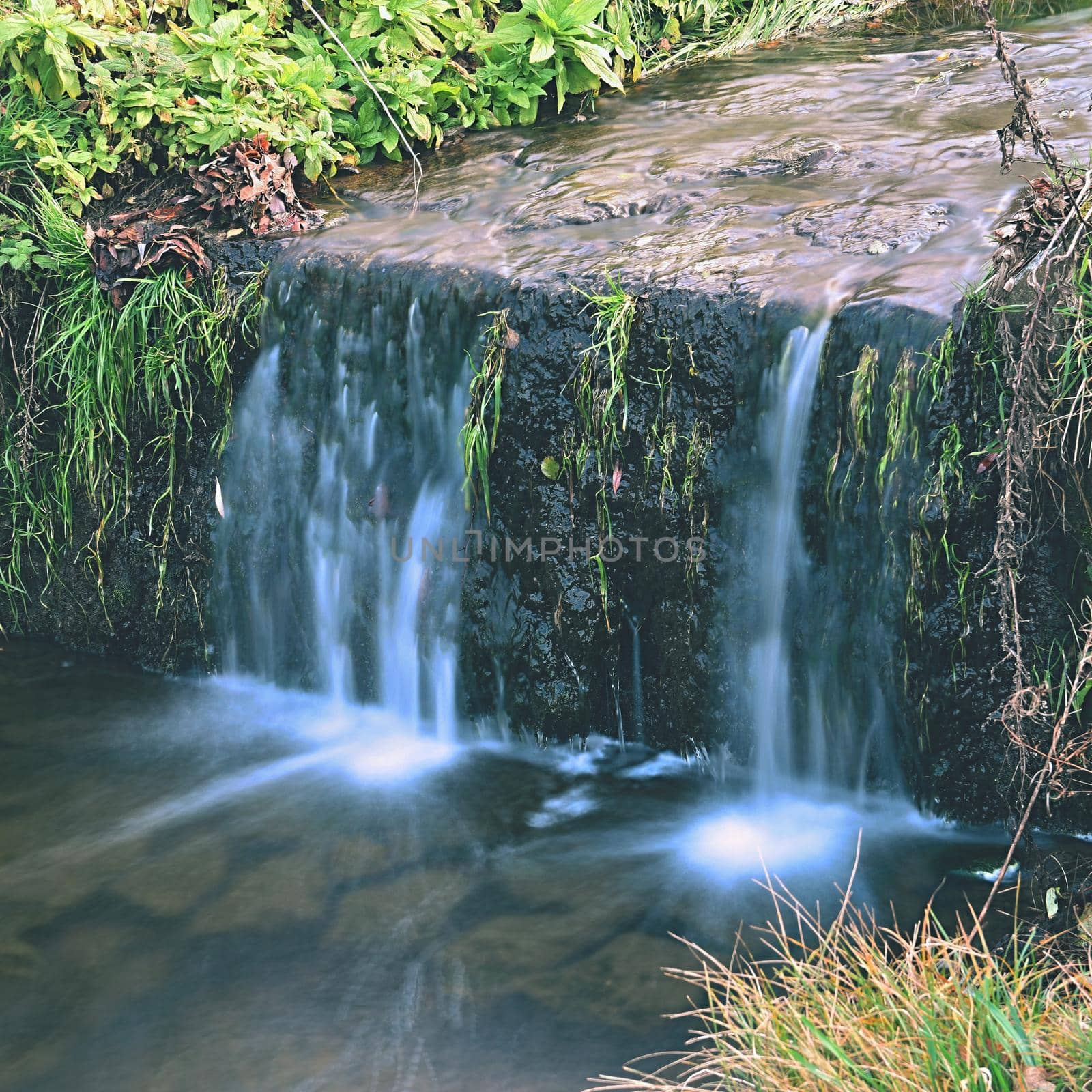 A beautiful clean brook in the countryside with a sink and running water. by Montypeter