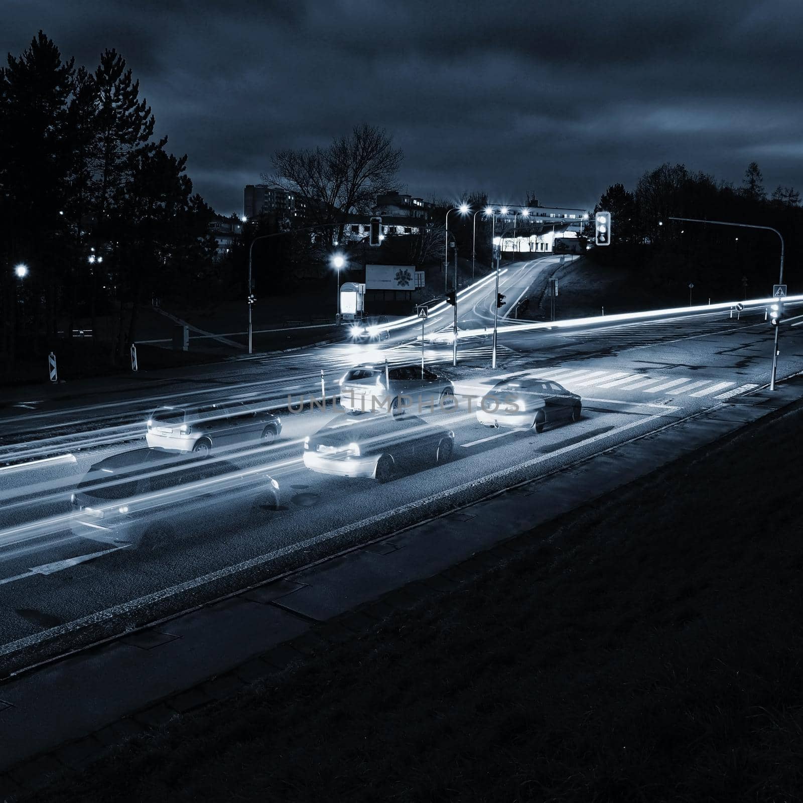 Night photo traffic on the road. Evening landscape with cars. Cars with lights and blurred color lines.