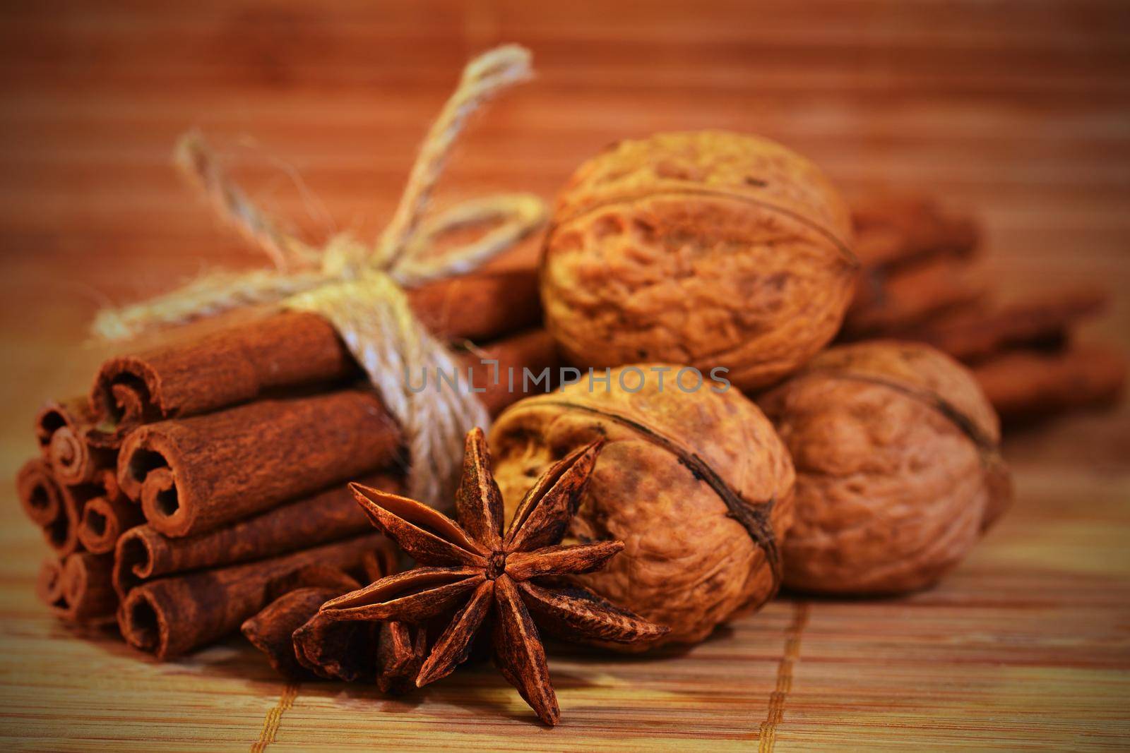 Cinnamon and star anise on a wooden background. Beautiful and fragrant spices for Christmas time and winter cooking season. by Montypeter