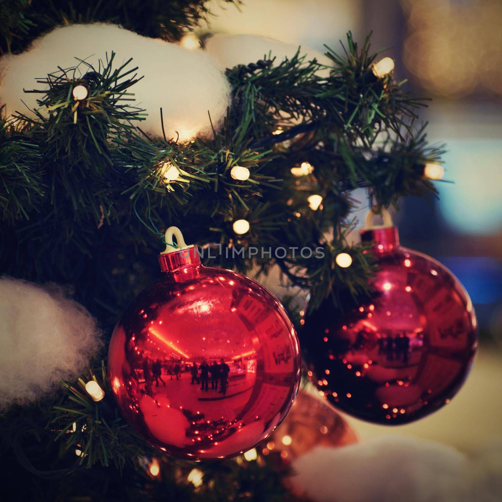 Colorful christmas Decoration. Winter holidays and traditional ornaments on a Christmas tree. Lighting chains - candles for seasonal background.