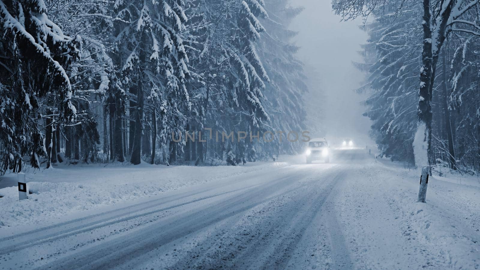 Snowy winter road with car. Dangerous car driving in the mountains in the winter. Concept for transportation, cars and travel.