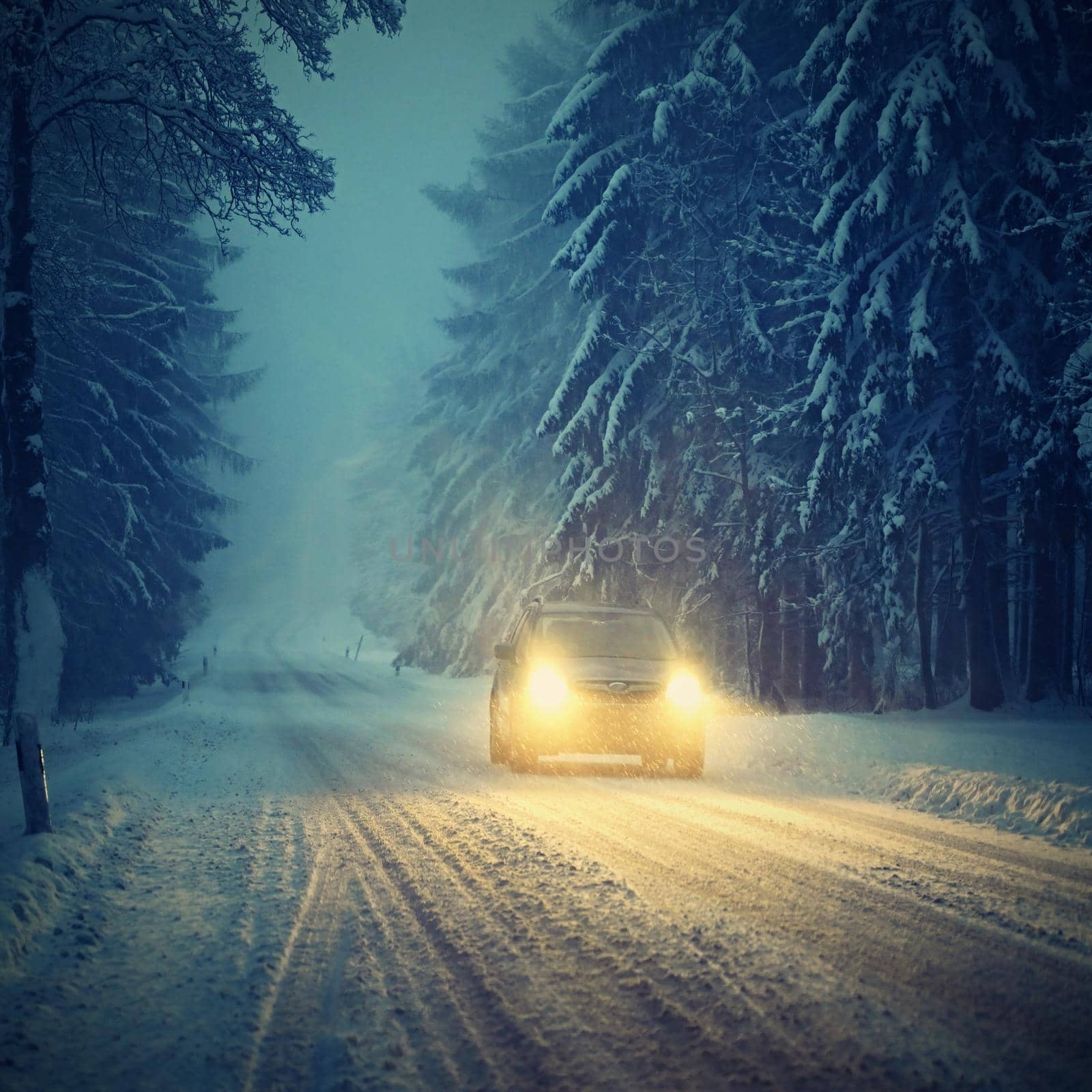 Snowy winter road with car. Dangerous car driving in the mountains in the winter. Concept for transportation, cars and travel. by Montypeter