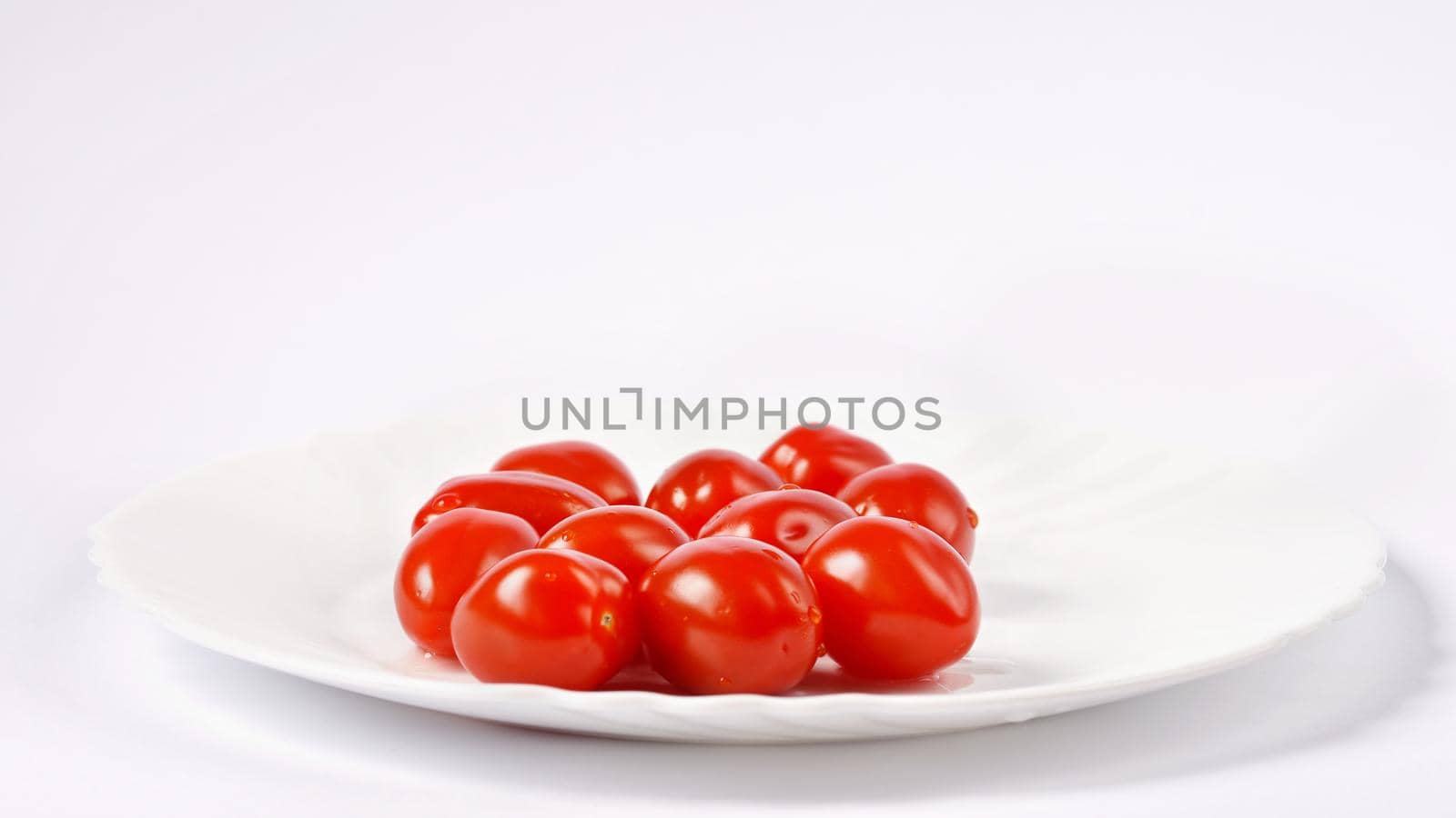 Cherry tomatoes stack isolated on white background