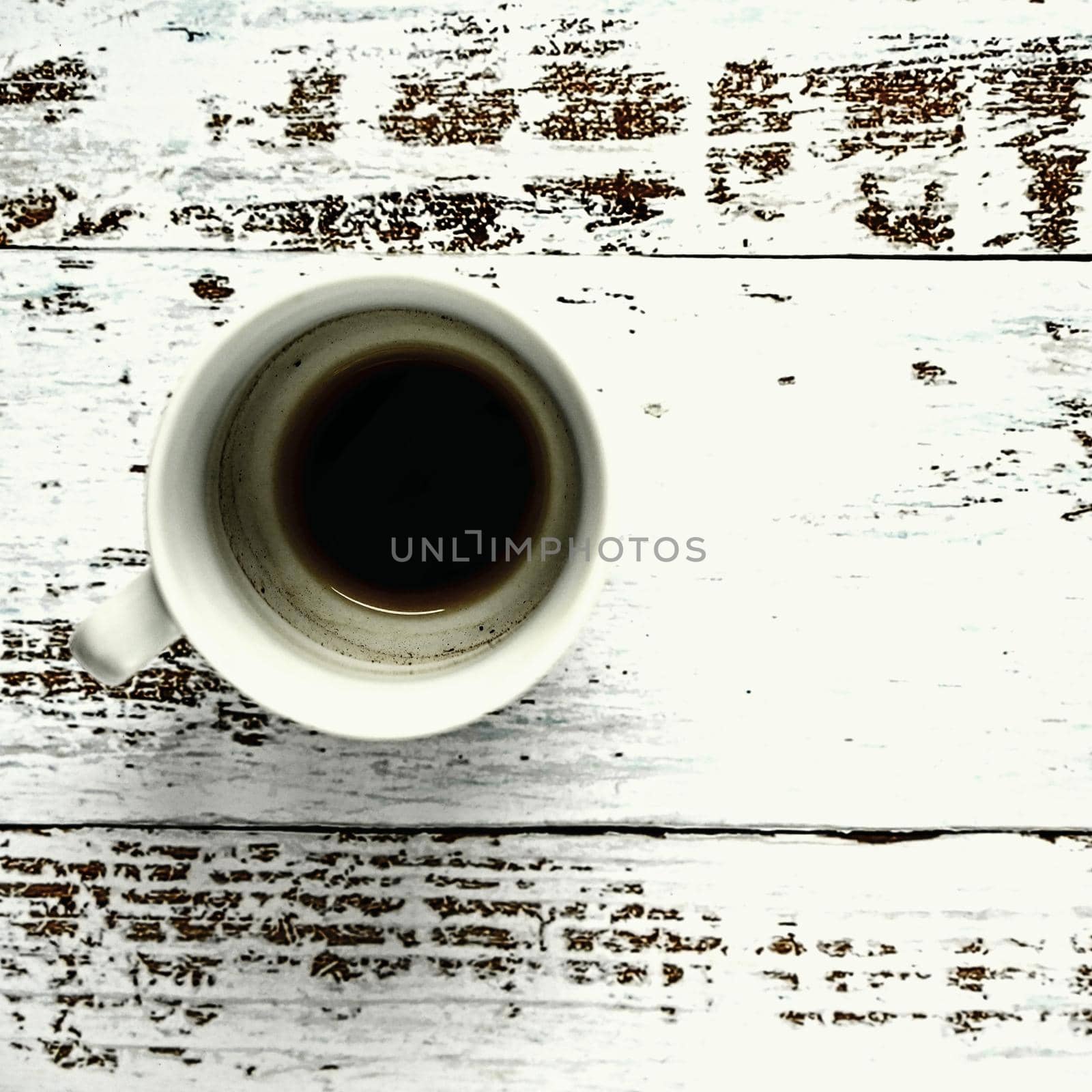 Blank and dirty white coffee mug on a wooden background by Montypeter