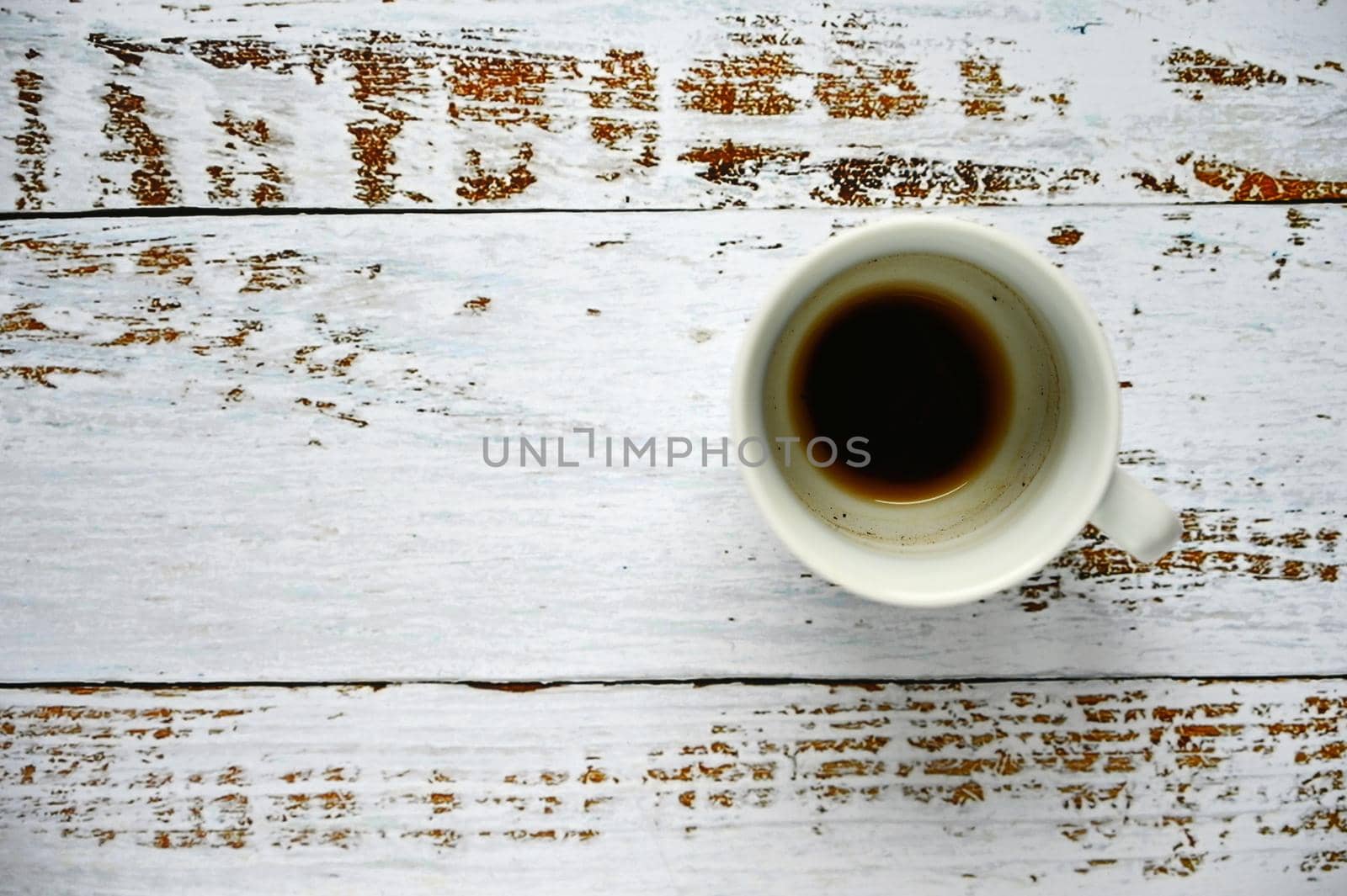 Blank and dirty white coffee mug on a wooden background.