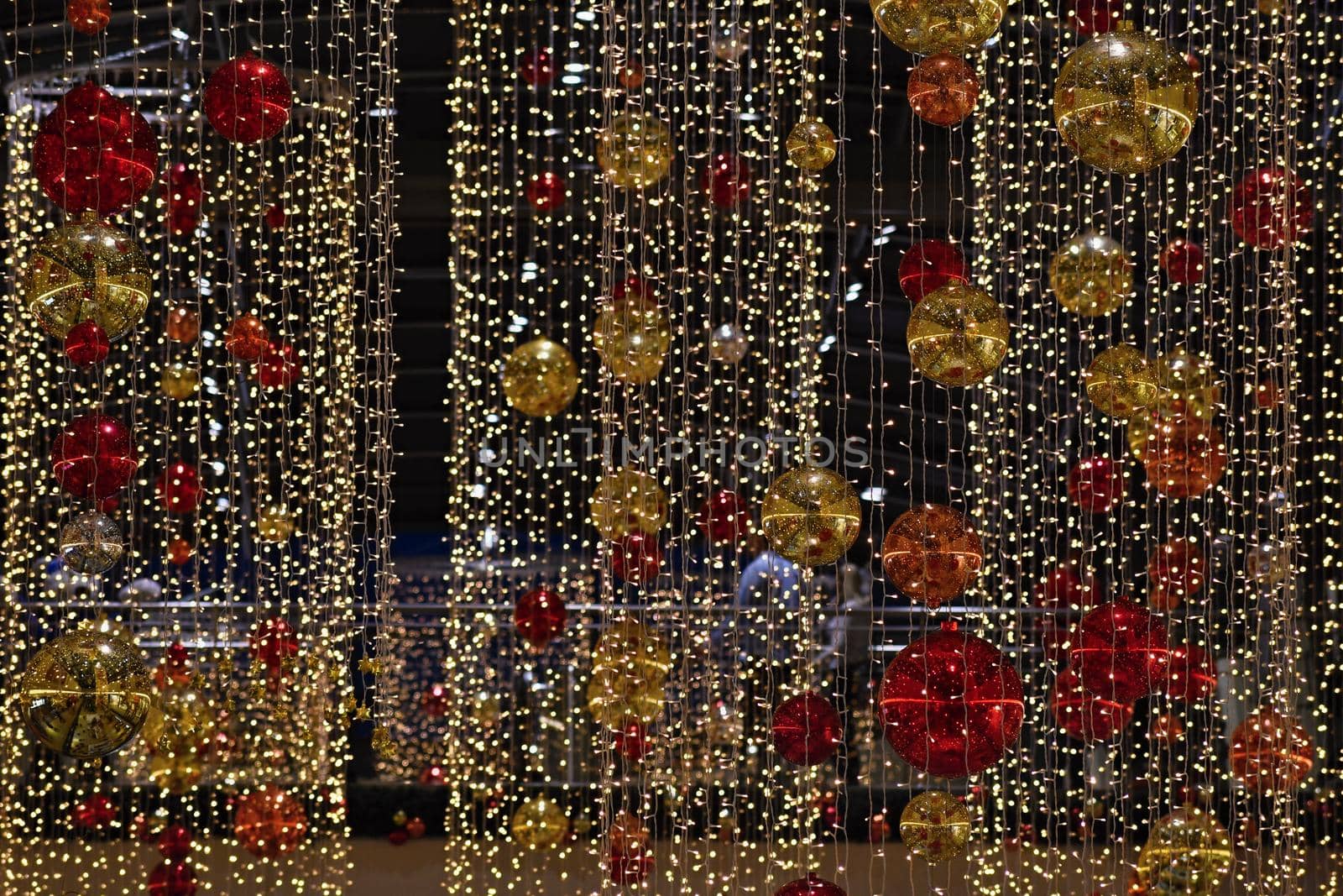 Colorful christmas Decoration. Winter holidays and traditional ornaments on a Christmas tree. Lighting chains - candles for seasonal background.