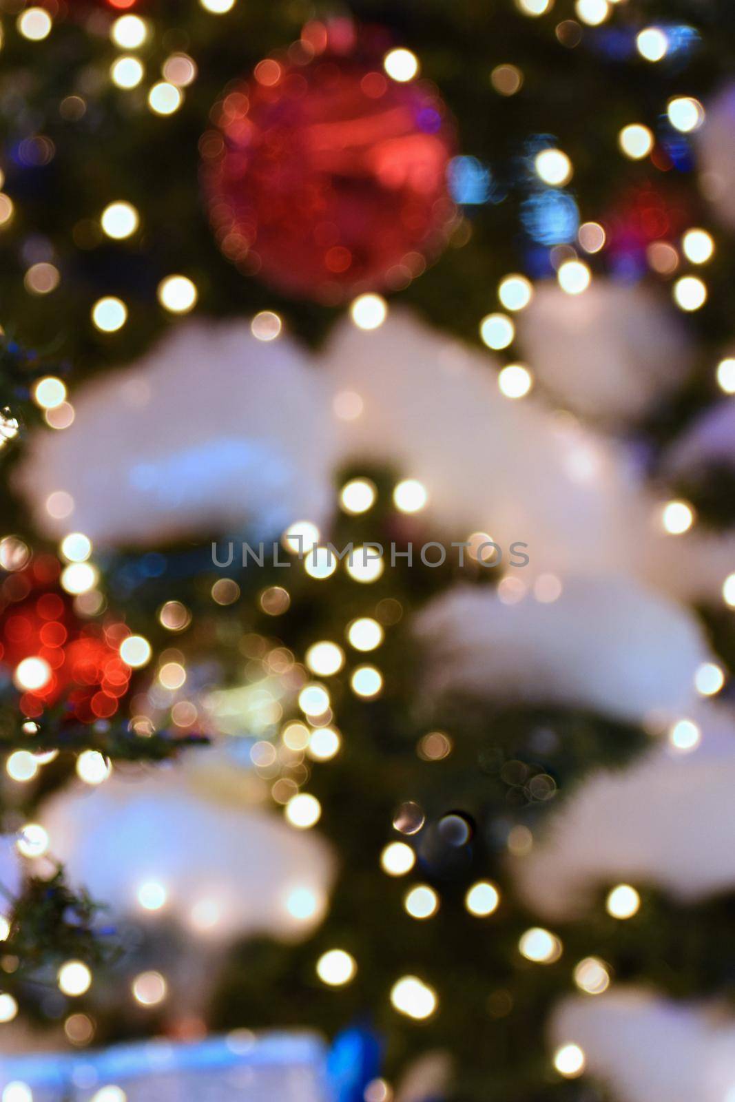 Colorful christmas Decoration. Winter holidays and traditional ornaments on a Christmas tree. Lighting chains - candles for seasonal background.