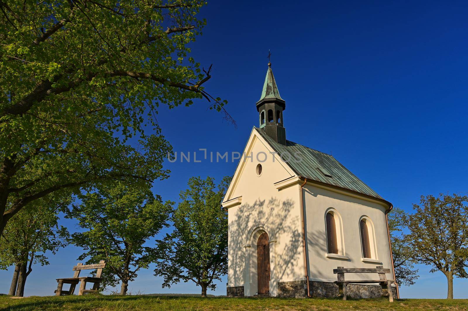 Beautiful little church with trees and blue sky. Brno-Lisen - Czech Republic. Chapel of Our Lady Help of Christians