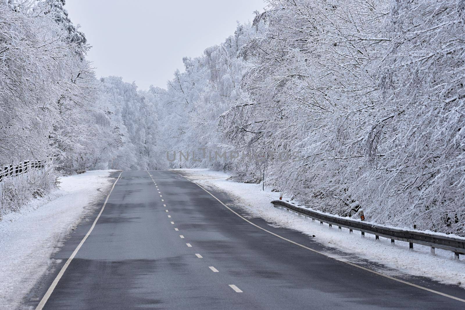 Road in winter. Snowy mountain path for a car. Concept for traveling and safe driving in winter by car.
