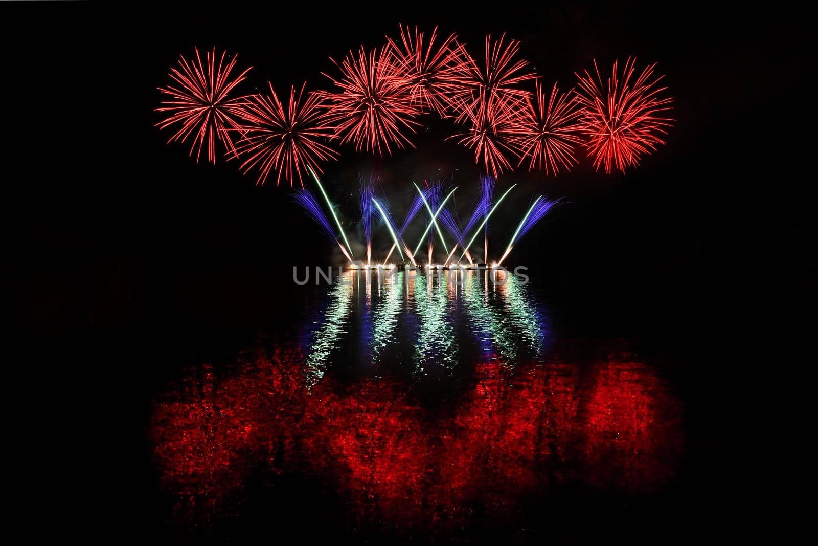 Beautiful colorful fireworks with reflections in water. Brno dam, the city of Brno-Europe. International Fireworks Competition.