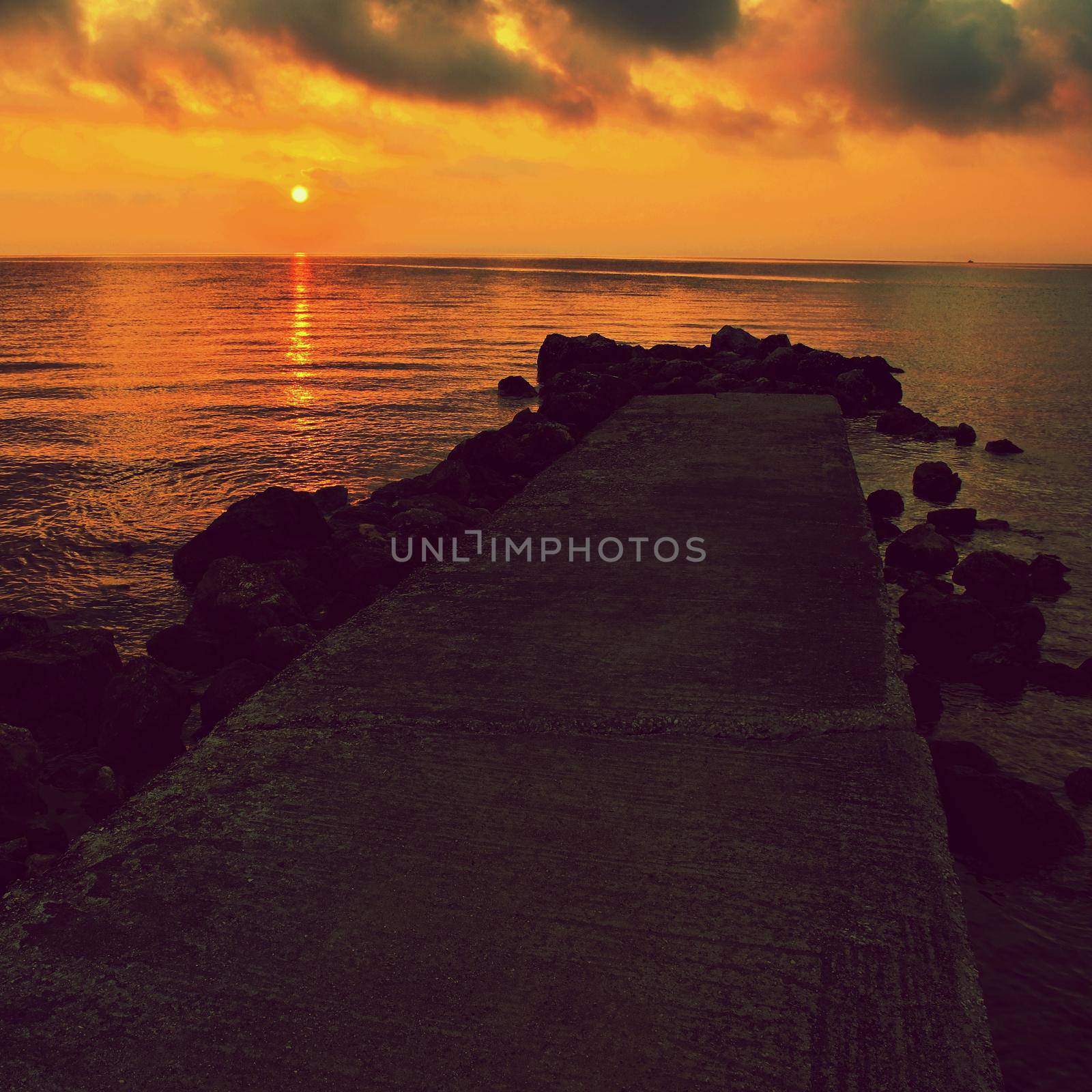 Sunset - sunrise by the sea on the beach. Beautiful romantic landscape with nature.