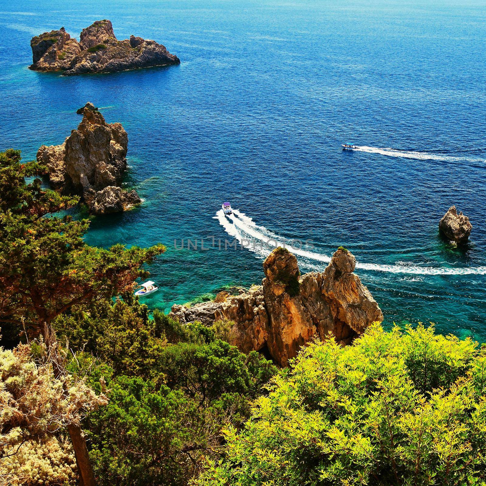 Beautiful beach and boats. Clean sea with a bay. Concept for travel, vacation and tourism. Great place for summer holidays and swimming. Paleokastritsa, Corfu island, Greece.