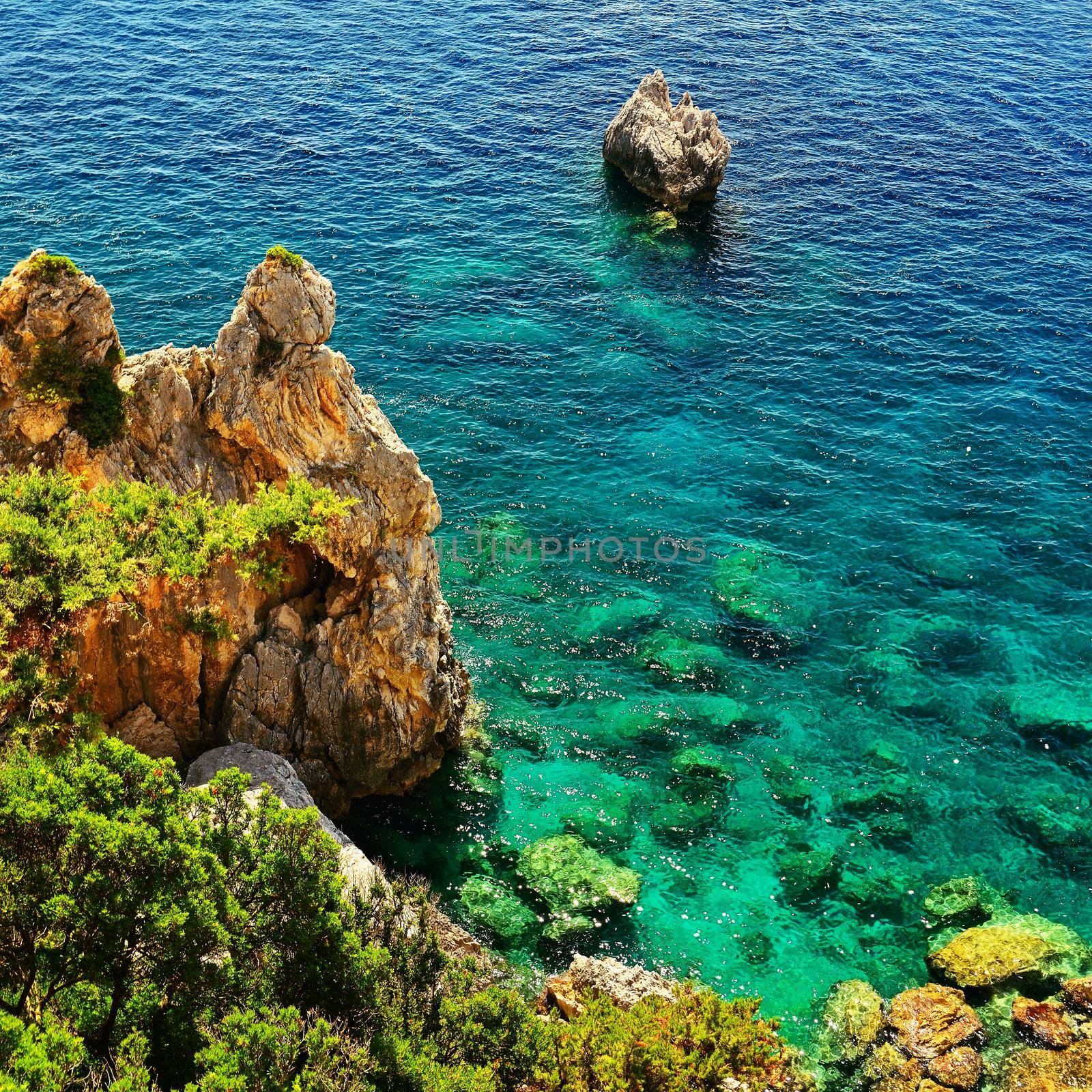 Beautiful beach and boats. Clean sea with a bay. Concept for travel, vacation and tourism. Great place for summer holidays and swimming. Paleokastritsa, Corfu island, Greece.