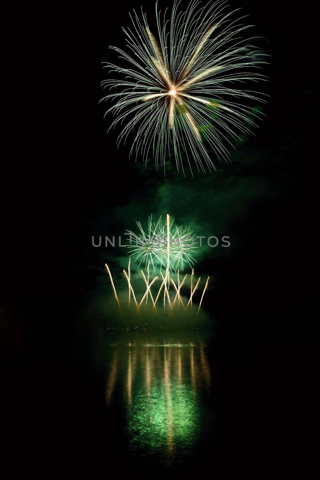 Beautiful colorful fireworks on the water surface with a clean black background. Fun festival and international contest of Firefighters from all over the world Ignis Brunensis 2017. Brno Dam - Czech Republic. by Montypeter