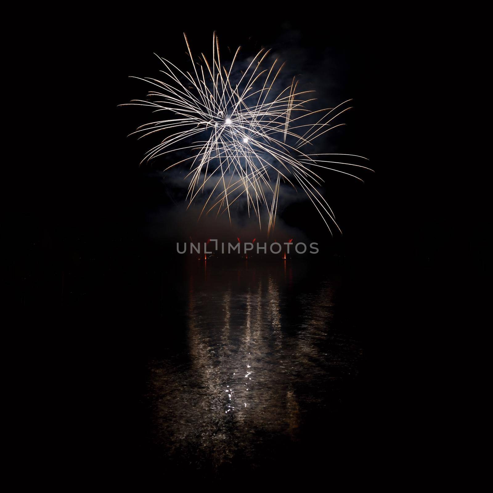 Beautiful colorful fireworks on the water surface with a clean black background. Fun festival and international contest of Firefighters from all over the world Ignis Brunensis 2017. Brno Dam - Czech Republic. by Montypeter